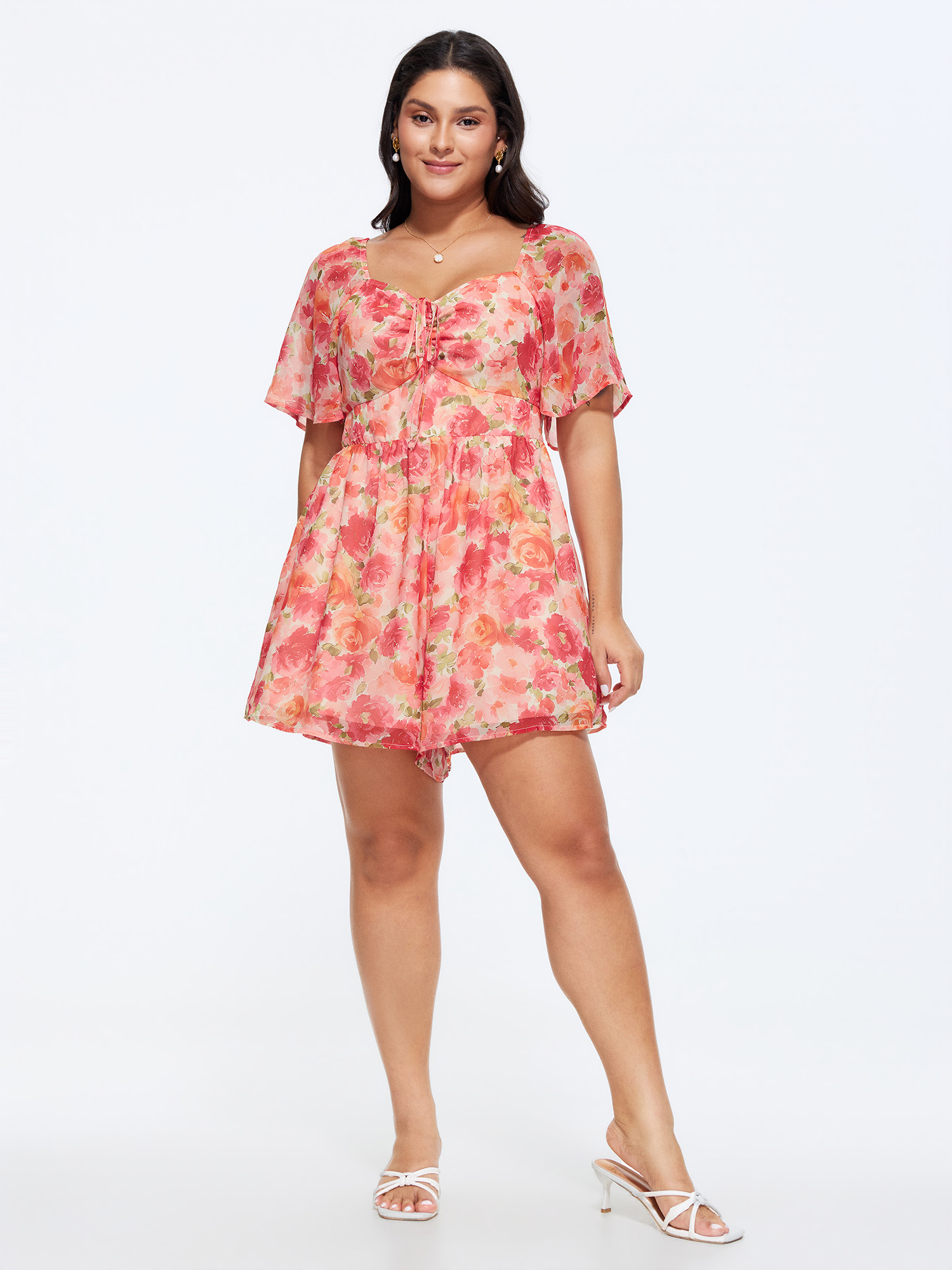 Side view of BloomChic Women's Plus Size Floral Print Ruched Bodice Romper Beanpastepowder Elegant Fitted 12/L