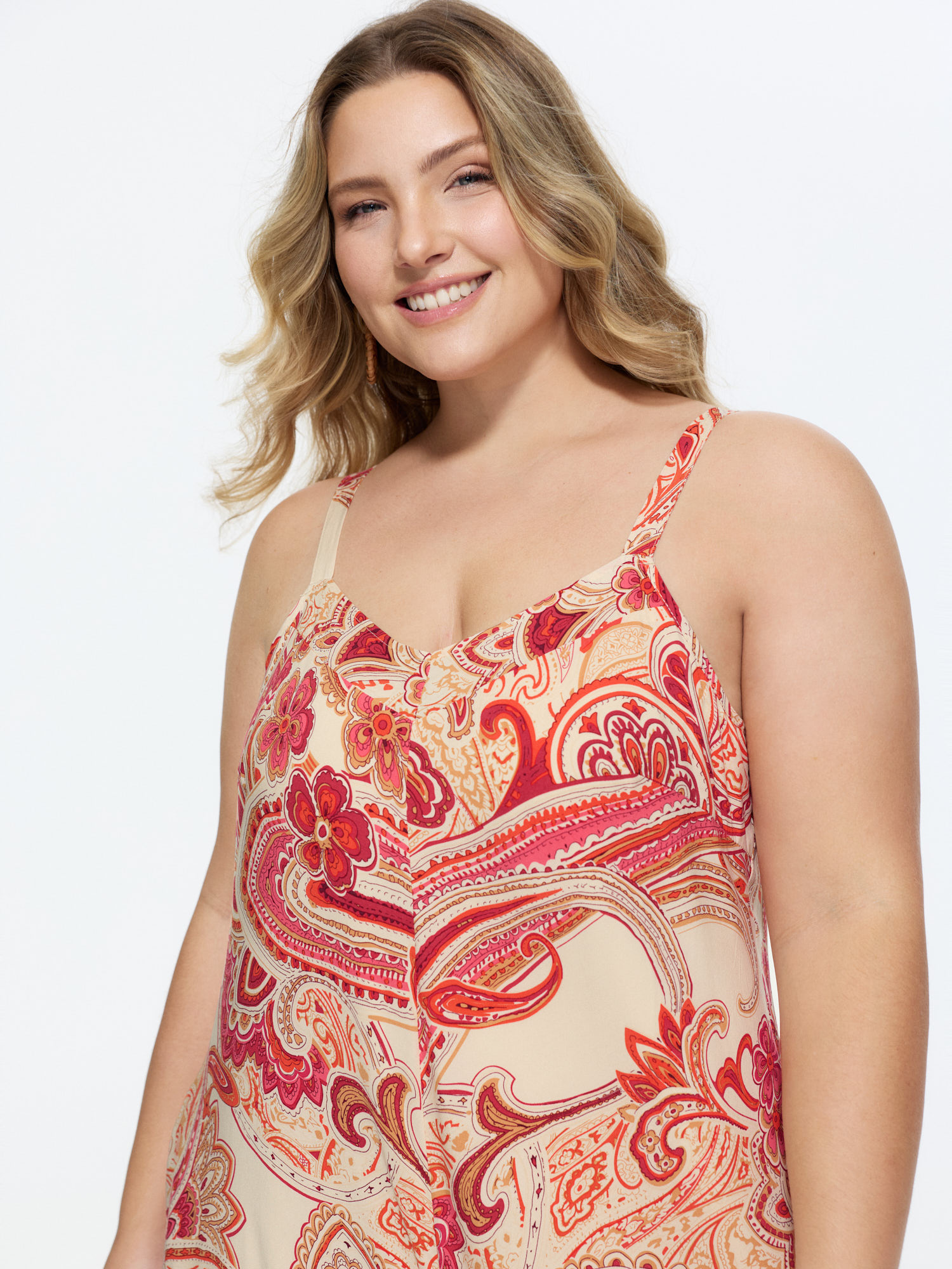 Side view of BloomChic Women's Plus Size Boho Print Asymmetrical Hem Jumpsuit Scarlet Vacation 18-20/2X