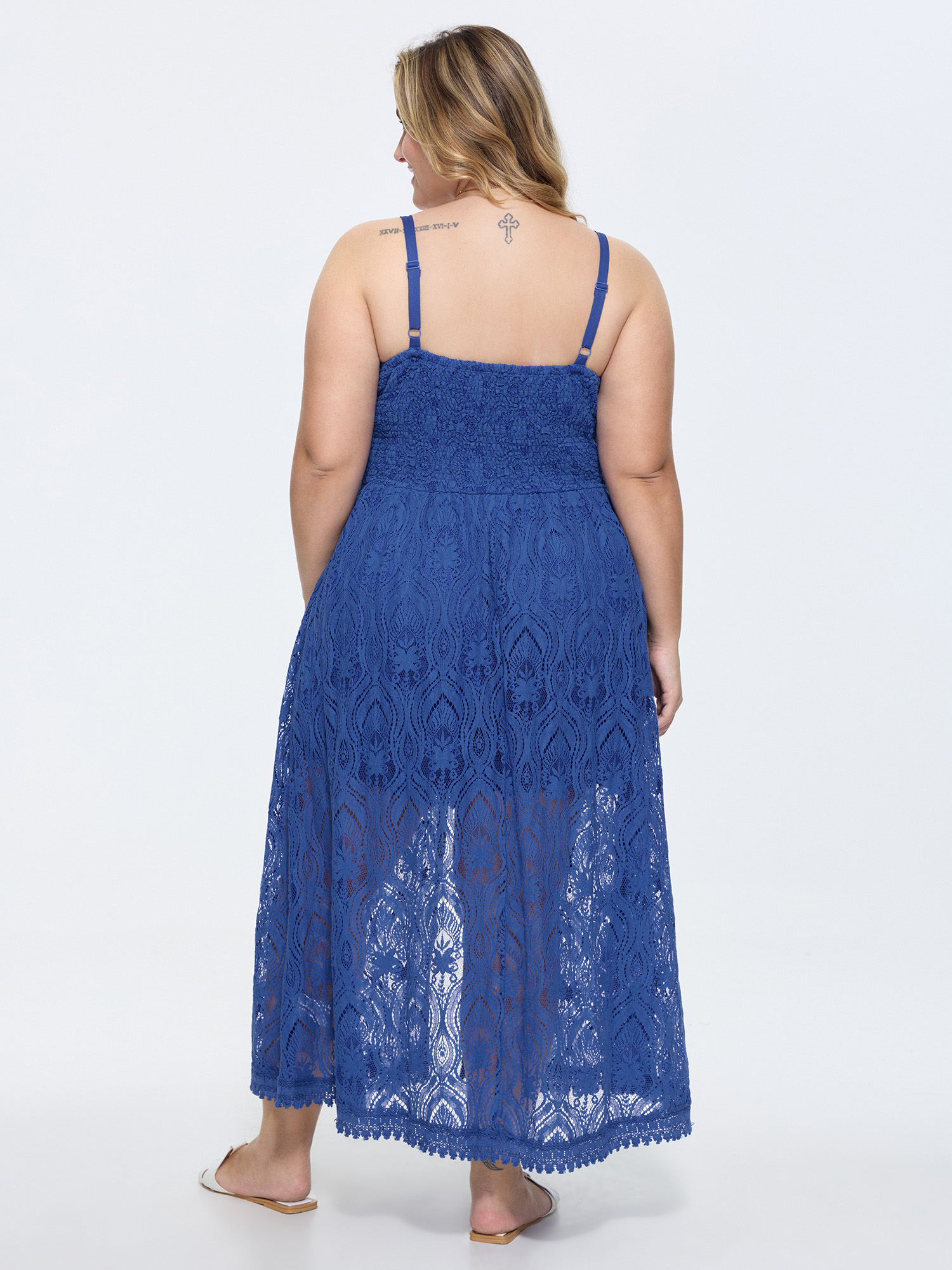 Side view of BloomChic Women's Plus Size Lace Textured Shirred Flowy Romper Navy Vacation 22-24/3X