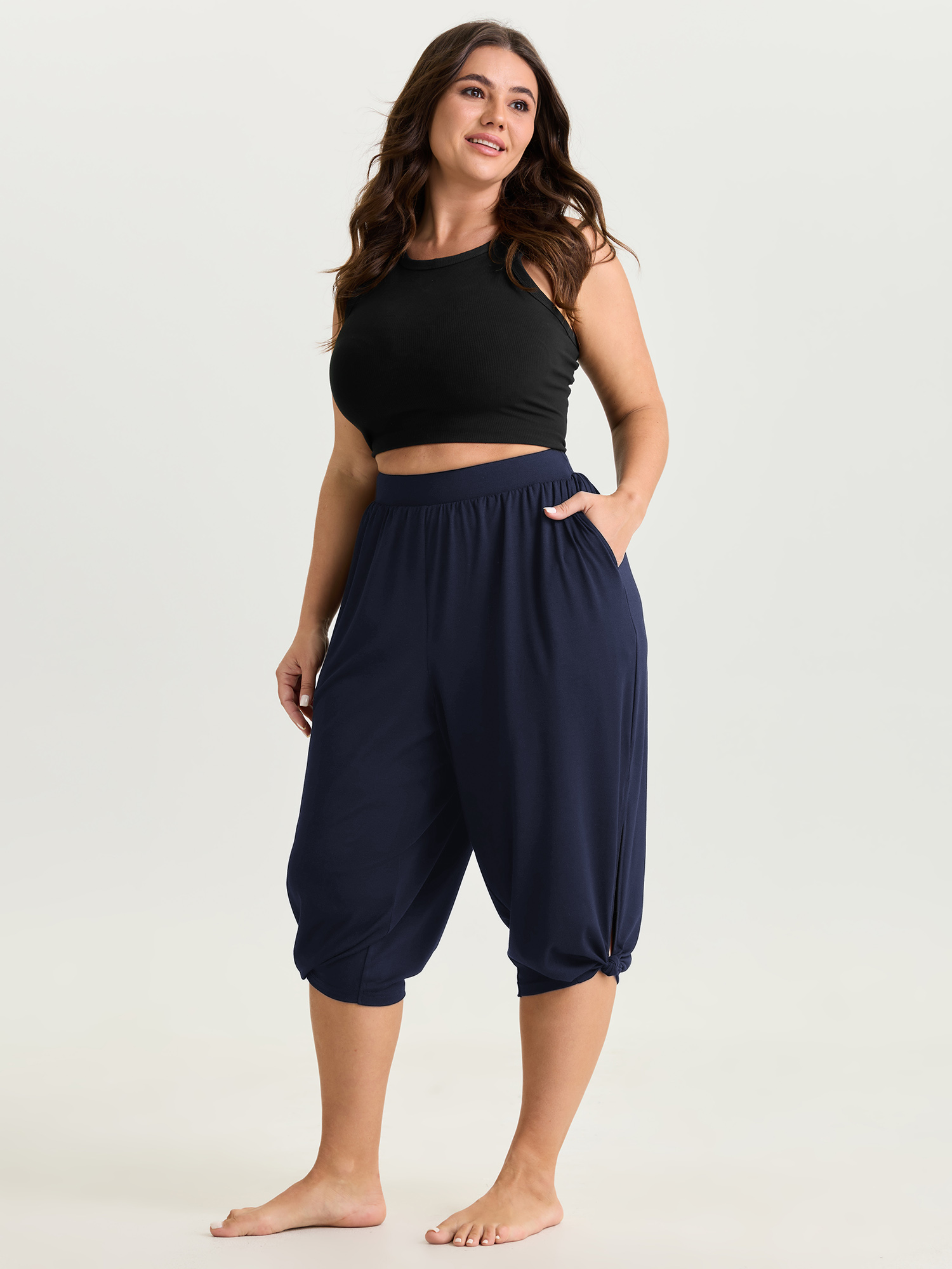 Side view of BloomChic Women's Plus Size Supersoft Stretchy Cuffed Cropped Lounge Bottoms Indigo Capri 18-20/2X