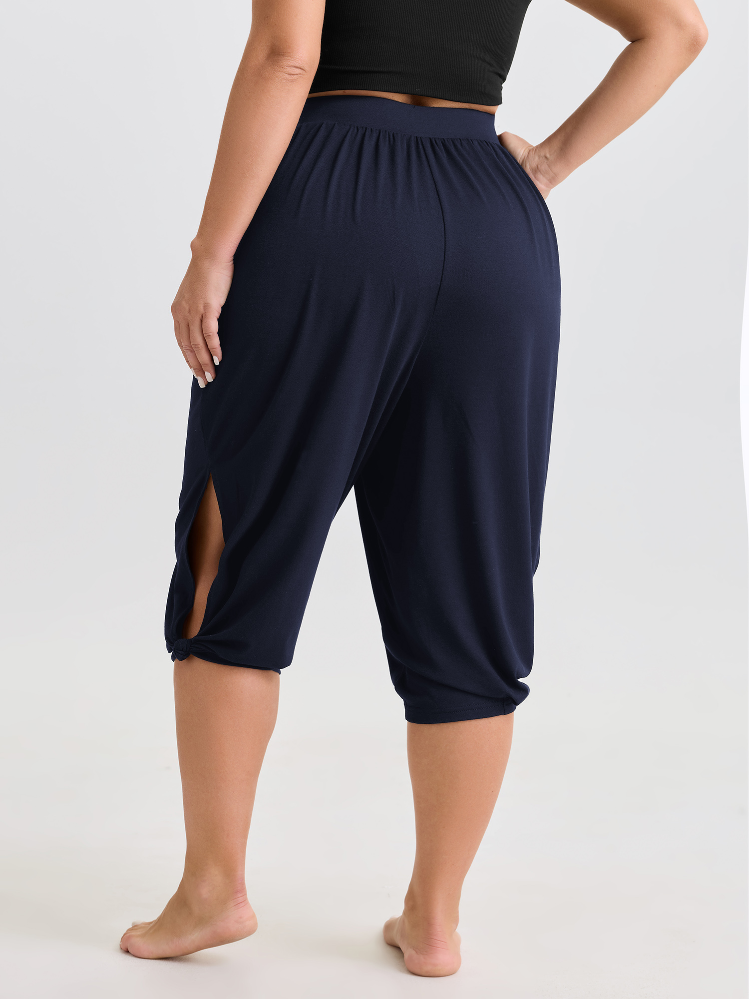 Side view of BloomChic Women's Plus Size Supersoft Stretchy Cuffed Cropped Lounge Bottoms Indigo Capri 18-20/2X