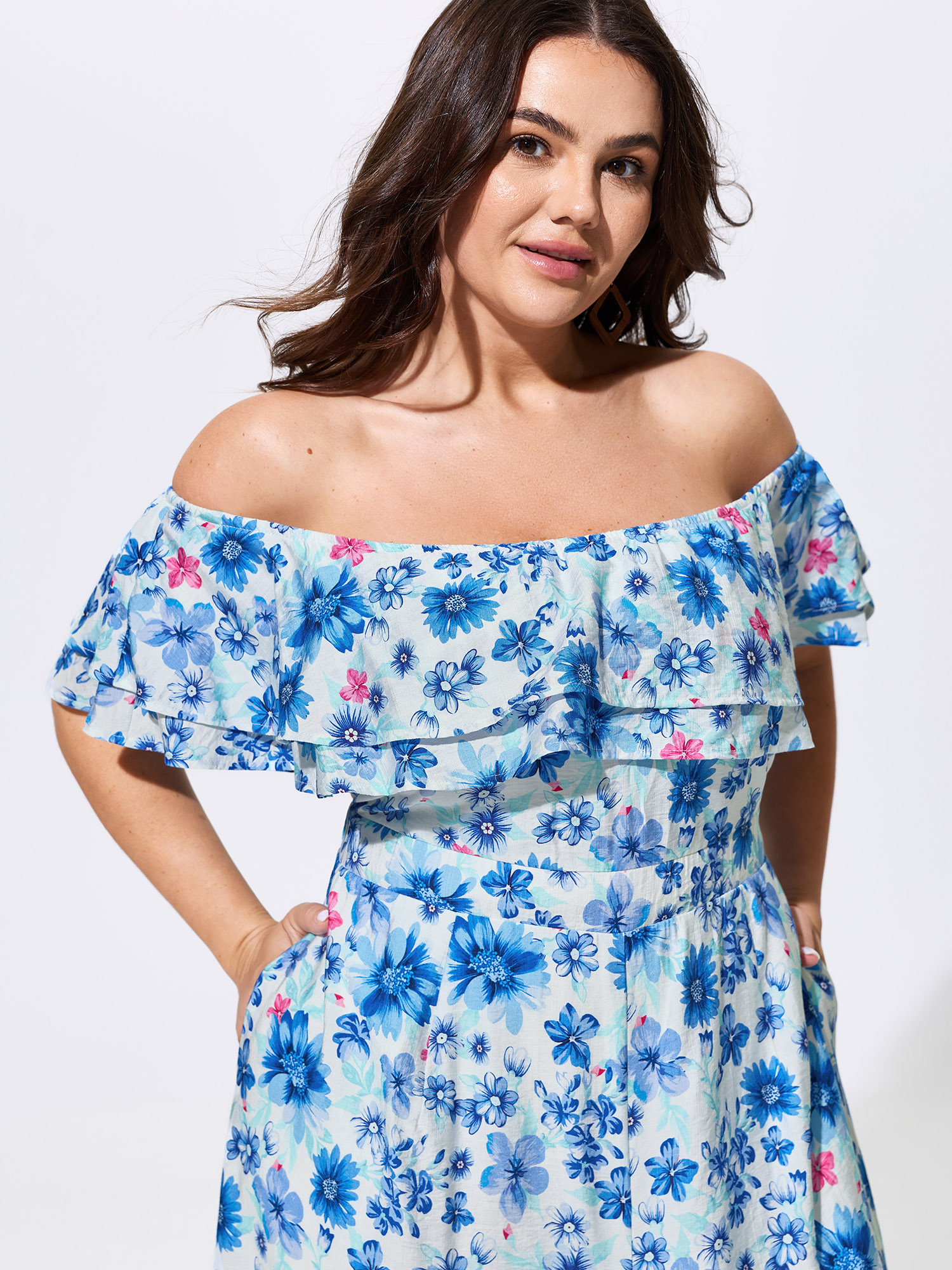 Side view of BloomChic Women's Plus Size Supersoft Floral Print Off-Shoulder Breezy Jumpsuit Skyblue Vacation 22-24/3X