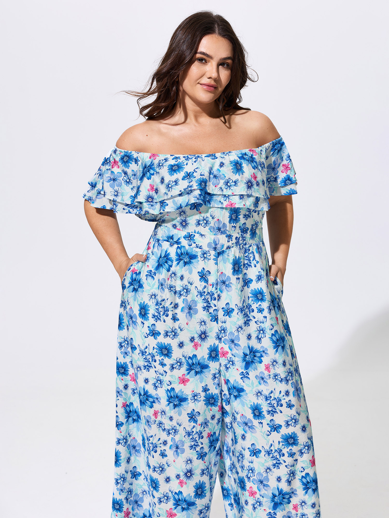 Side view of BloomChic Women's Plus Size Supersoft Floral Print Off-Shoulder Breezy Jumpsuit Skyblue Vacation 22-24/3X