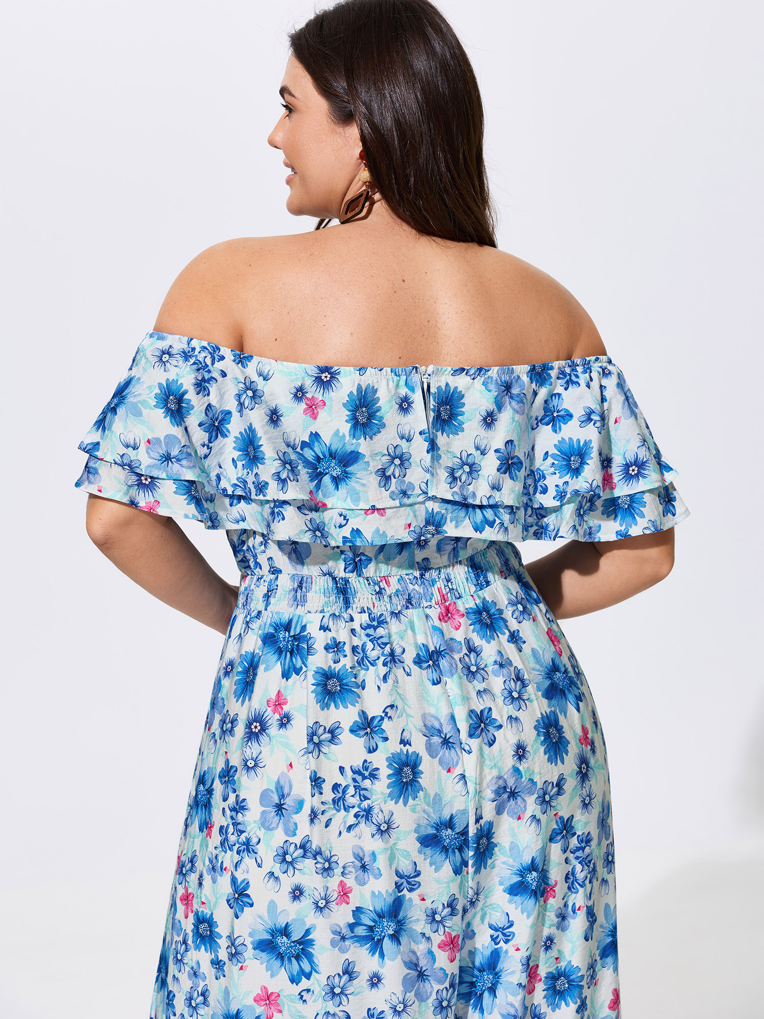 Side view of BloomChic Women's Plus Size Supersoft Floral Print Off-Shoulder Breezy Jumpsuit Skyblue Vacation 22-24/3X
