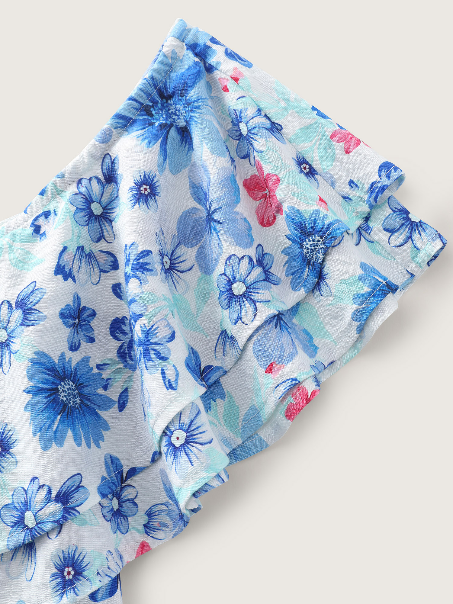 Side view of BloomChic Women's Plus Size Supersoft Floral Print Off-Shoulder Breezy Jumpsuit Skyblue Vacation 22-24/3X