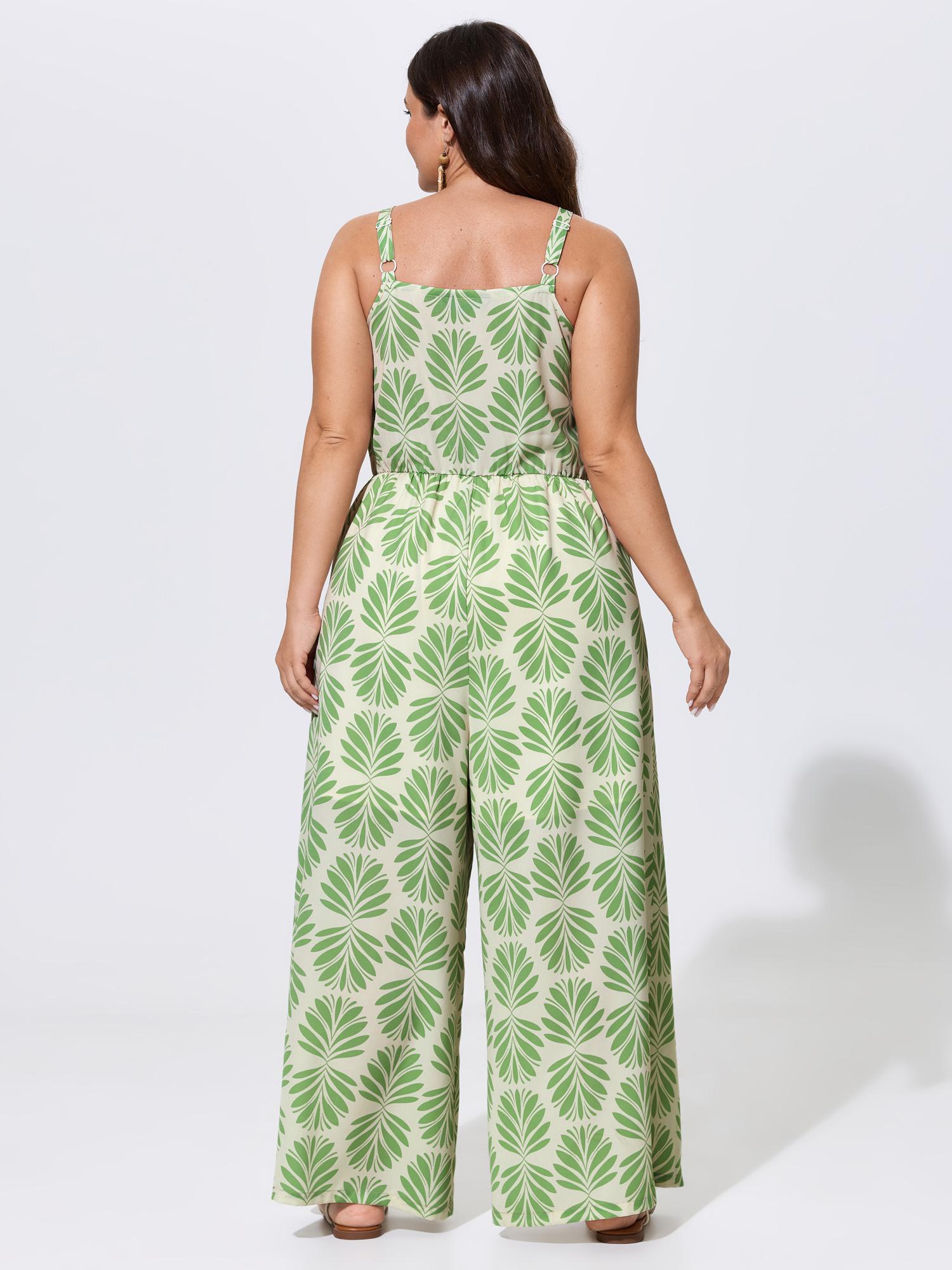 Side view of BloomChic Women's Plus Size Silhouette Floral Print Sweetheart Jumpsuit LightGreen Vacation 12/L