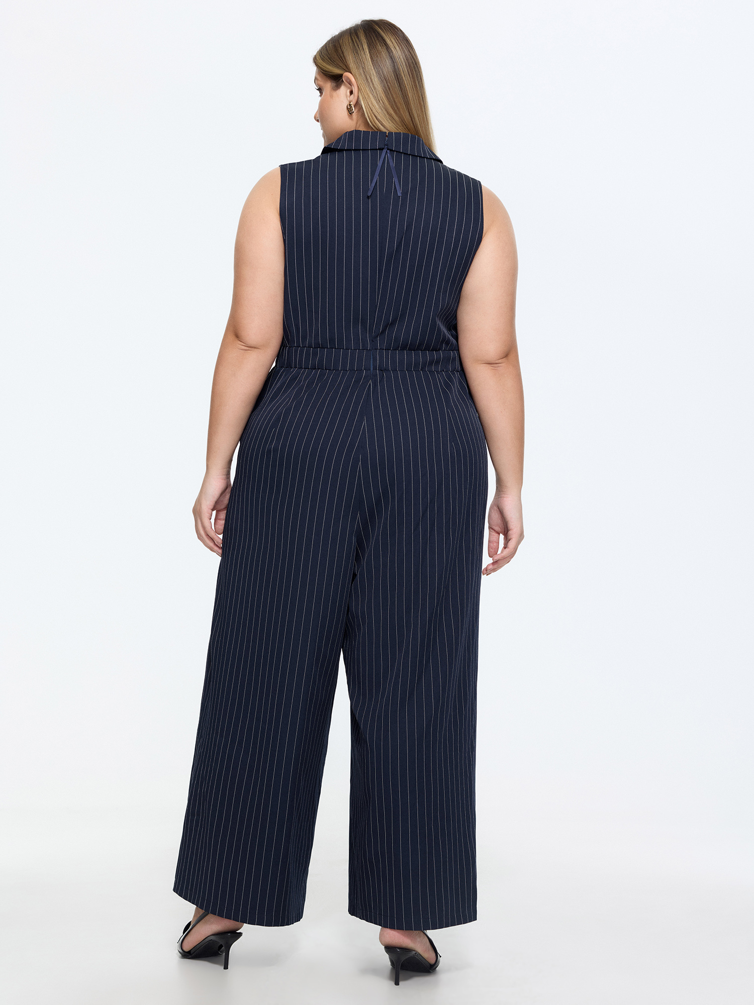 Side view of BloomChic Women's Plus Size Striped Print Collared Sleeveless Jumpsuit Indigo Office Fitted 12/L