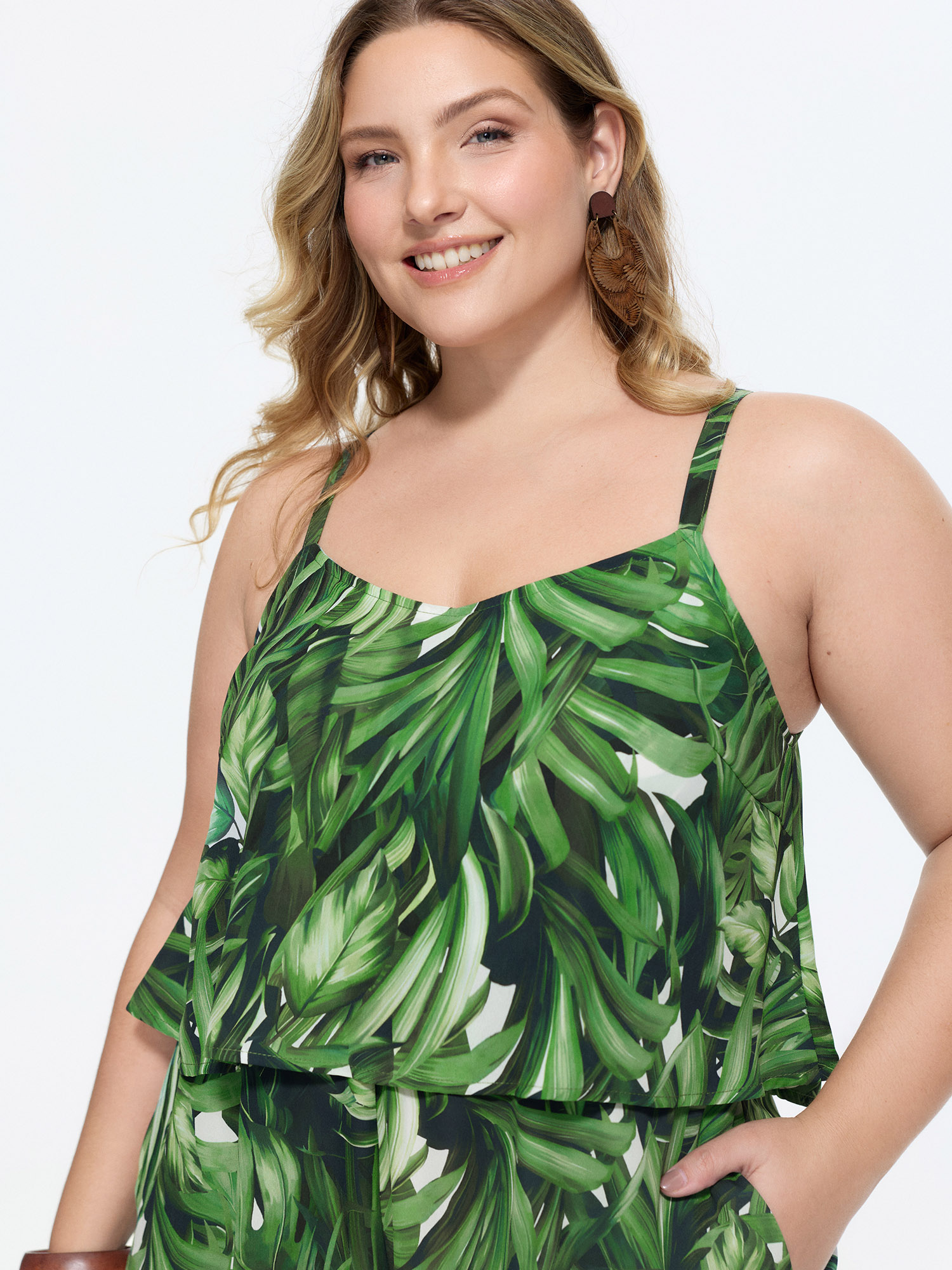 Side view of BloomChic Women's Plus Size Tropical Print Wide-Leg Breezy Romper Truegreen Vacation 10/M