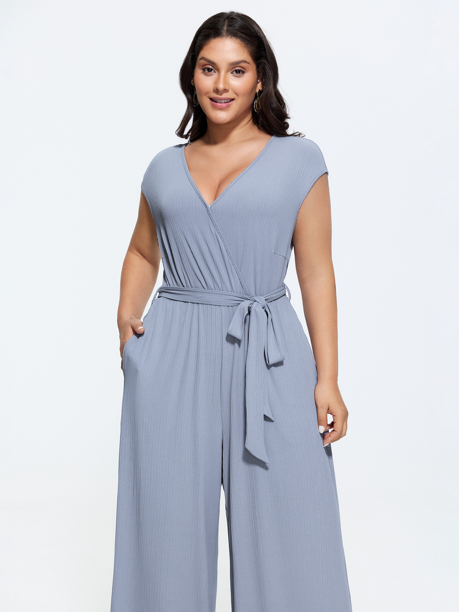 Side view of BloomChic Women's Plus Size Textured Waist Side-Tie Wide-Leg Jumpsuit Stone Elegant 22-24/3X