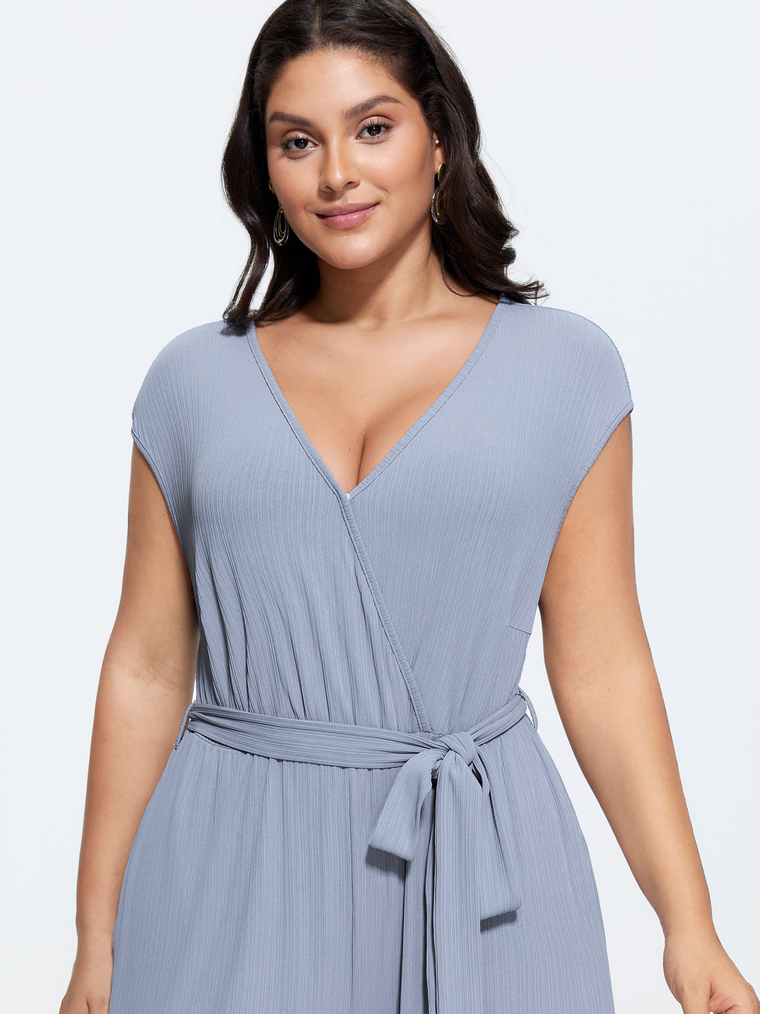 Side view of BloomChic Women's Plus Size Textured Waist Side-Tie Wide-Leg Jumpsuit Stone Elegant 22-24/3X