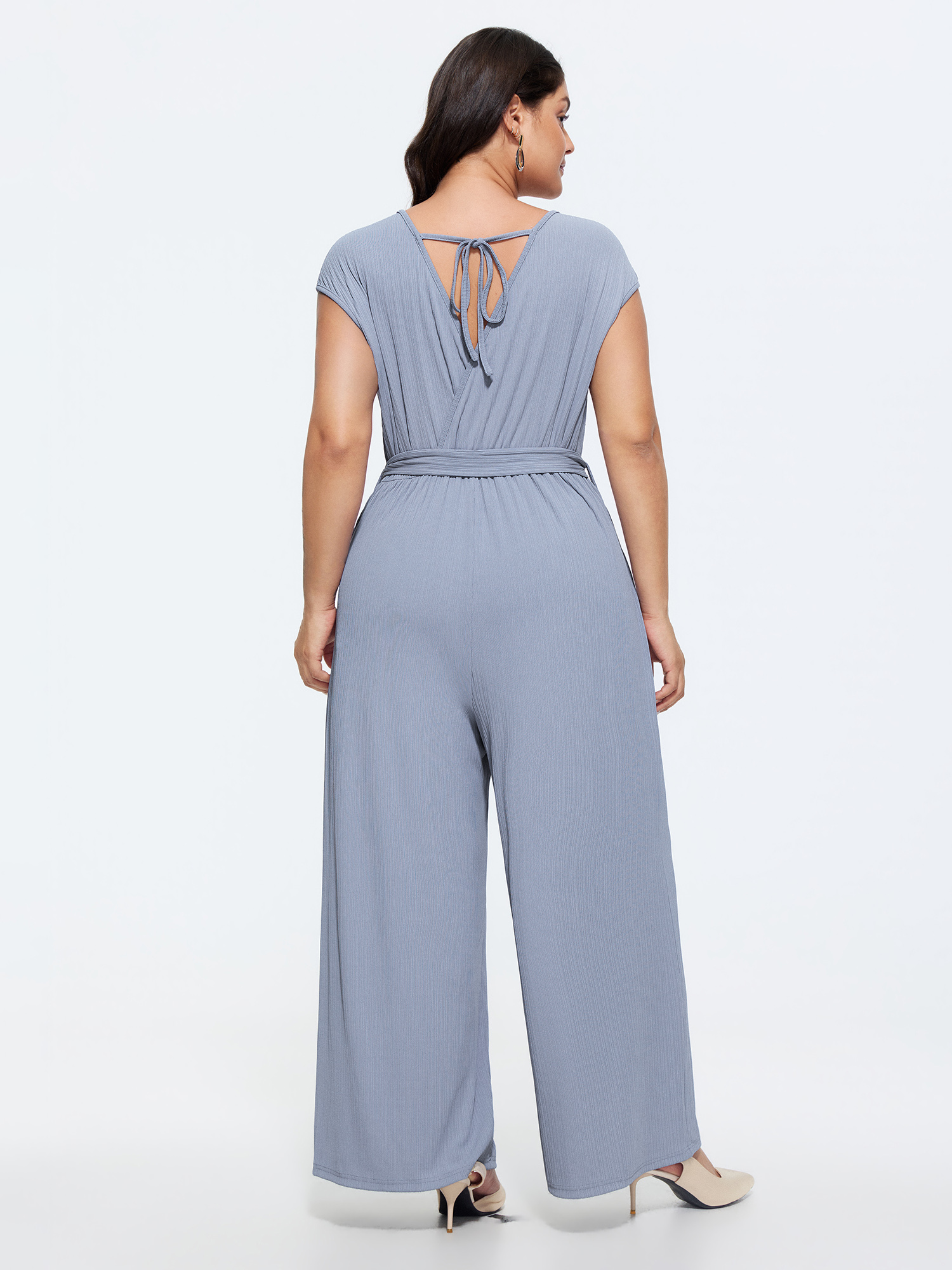 Side view of BloomChic Women's Plus Size Textured Waist Side-Tie Wide-Leg Jumpsuit Stone Elegant 22-24/3X