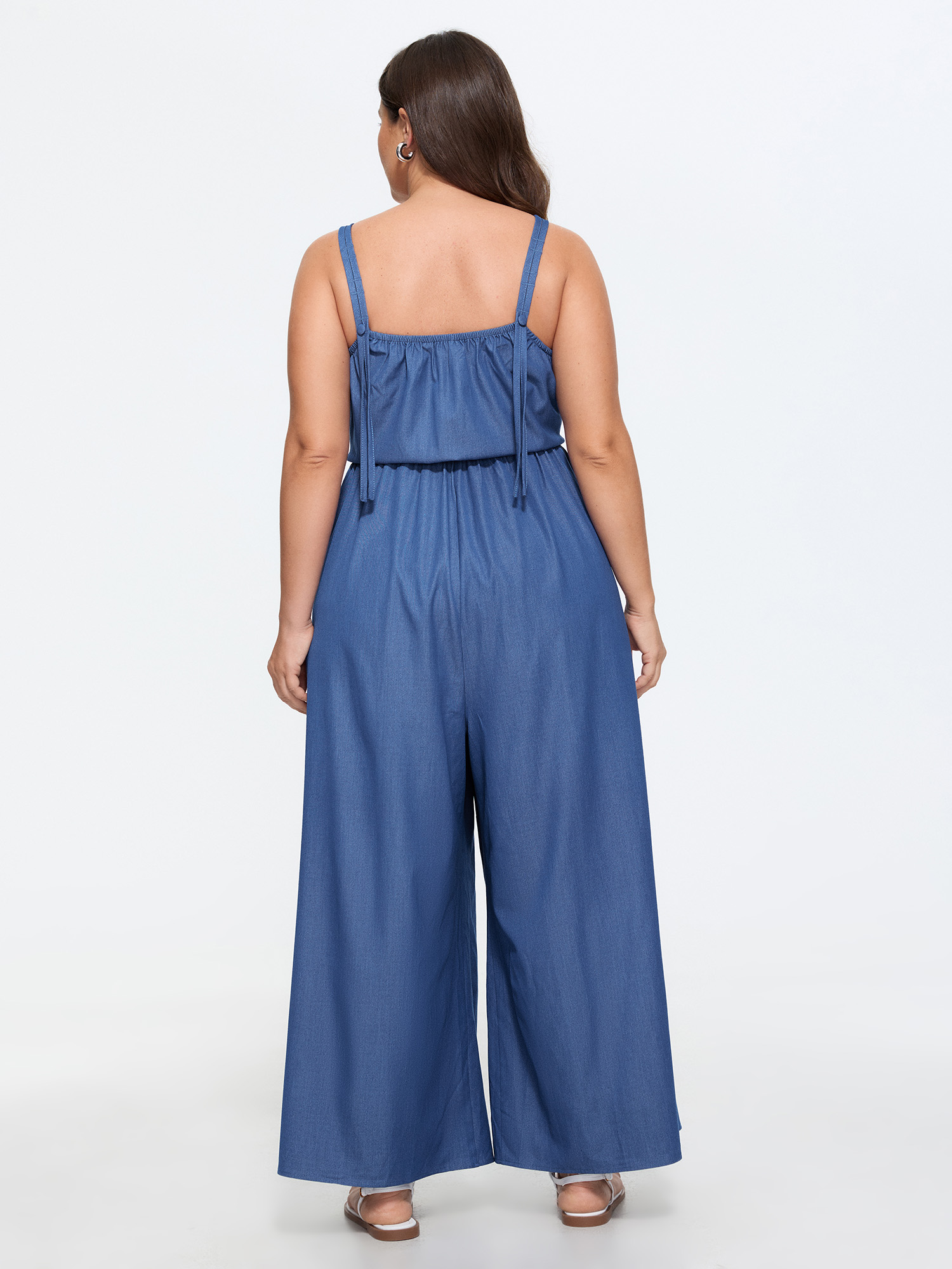 Side view of BloomChic Women's Plus Size Supersoft Pleated Sleeveless Faux Denim Jumpsuit Mediumblue Casual 10/M