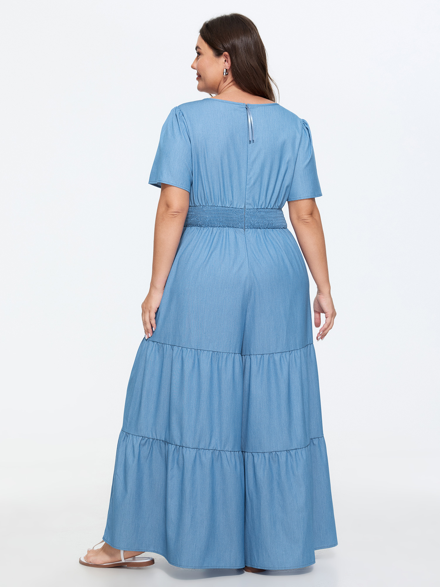 Side view of BloomChic Women's Plus Size Supersoft Button Detail Shirred Waist Faux Denim Jumpsuit Cerulean Casual 14-16/1X