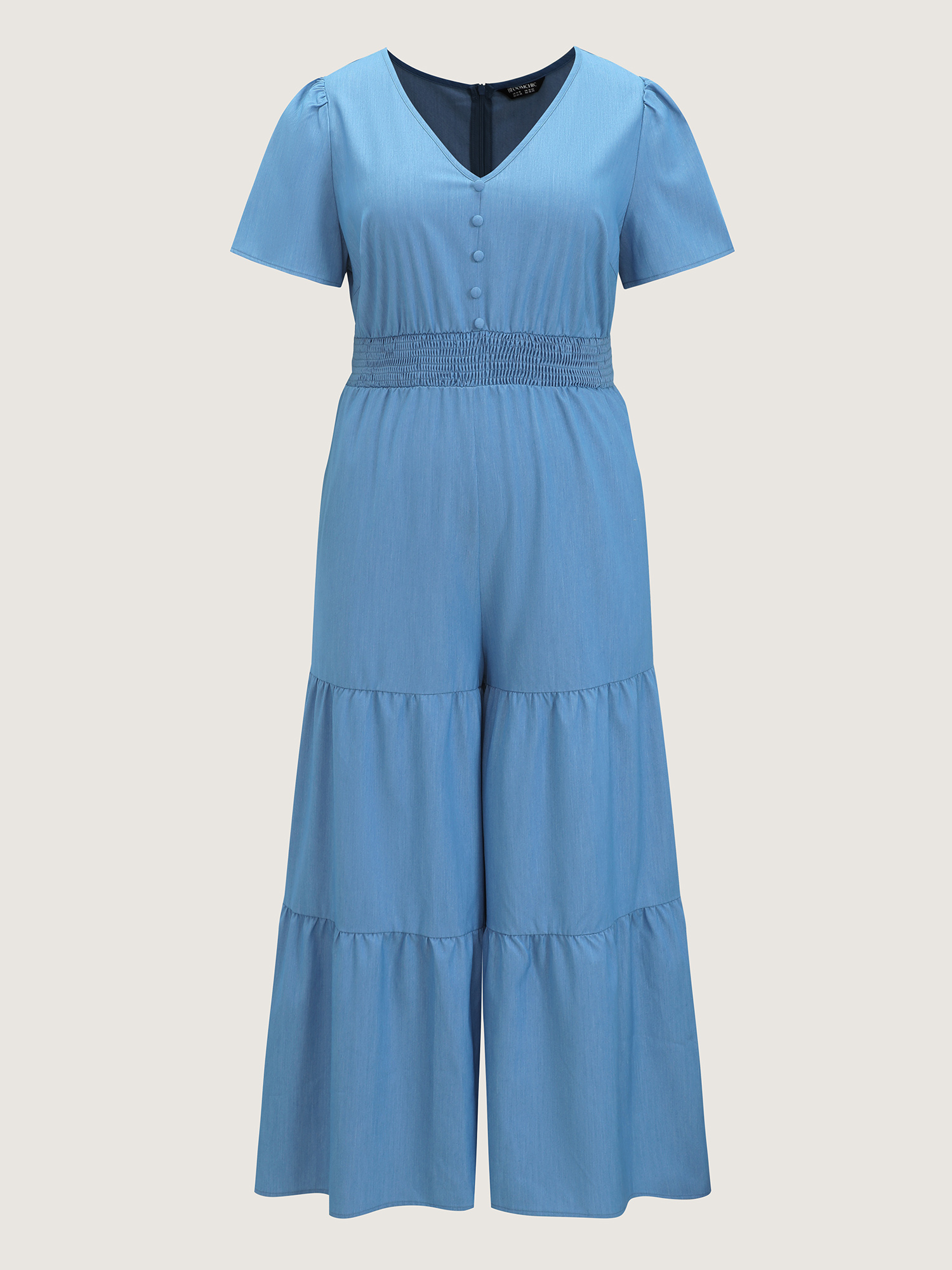 Side view of BloomChic Women's Plus Size Supersoft Button Detail Shirred Waist Faux Denim Jumpsuit Cerulean Casual 14-16/1X