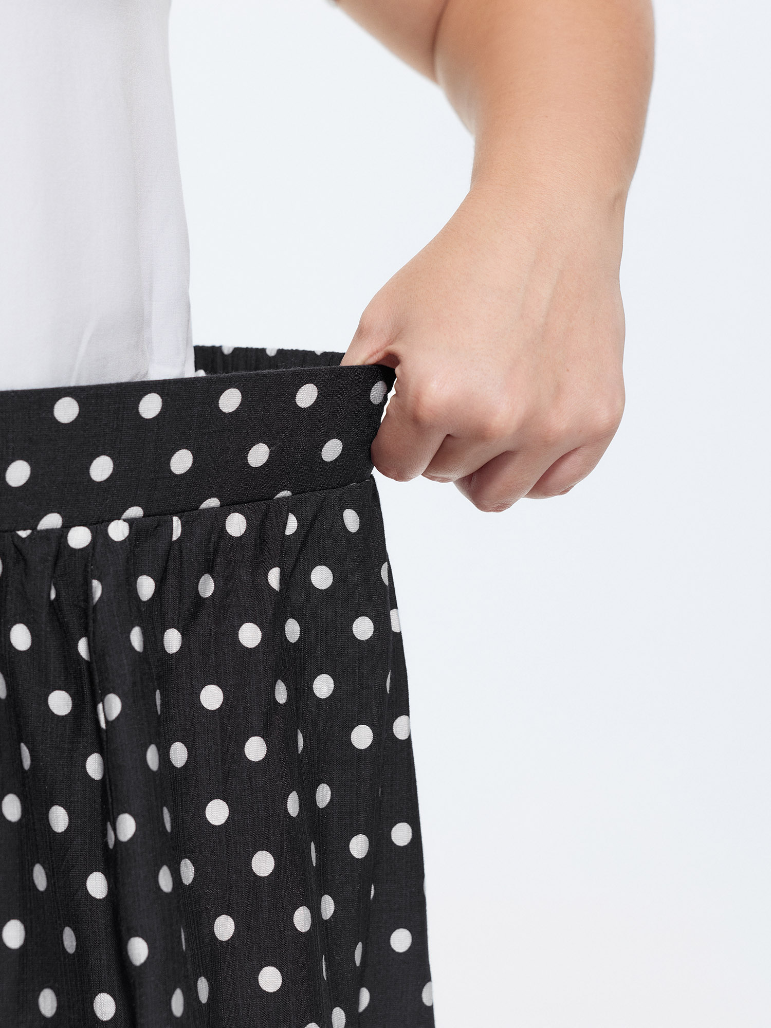 Side view of BloomChic Women's Plus Size Polka Dots Charm Maxi Skirt Black Non Flared Elegant 30/6X