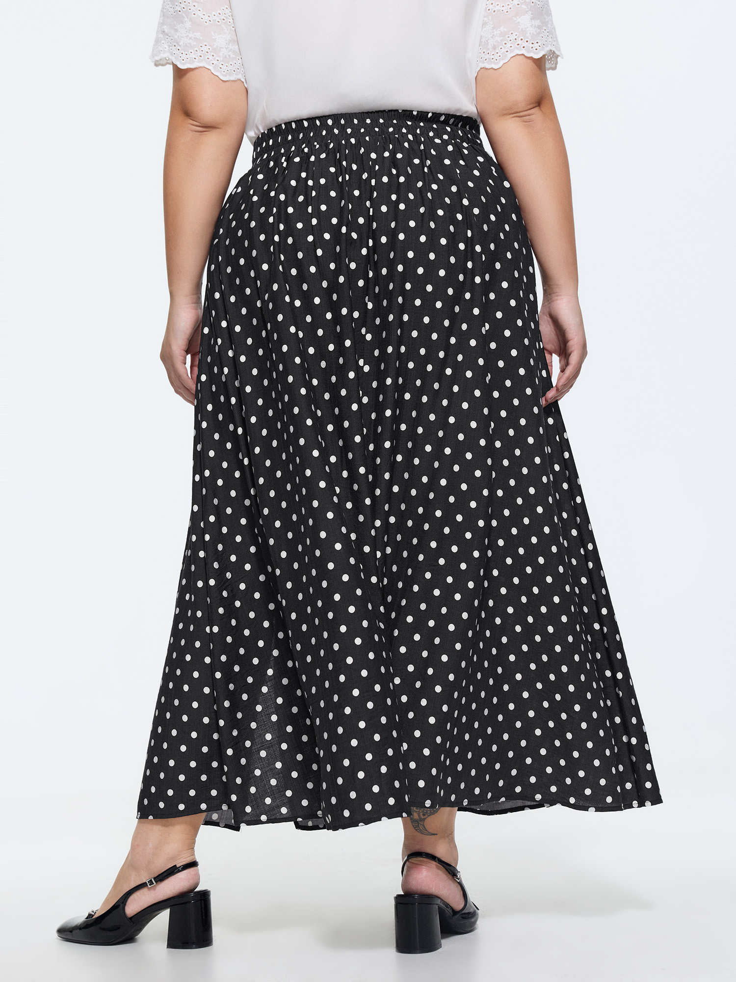 Side view of BloomChic Women's Plus Size Polka Dots Charm Maxi Skirt Black Non Flared Elegant 30/6X