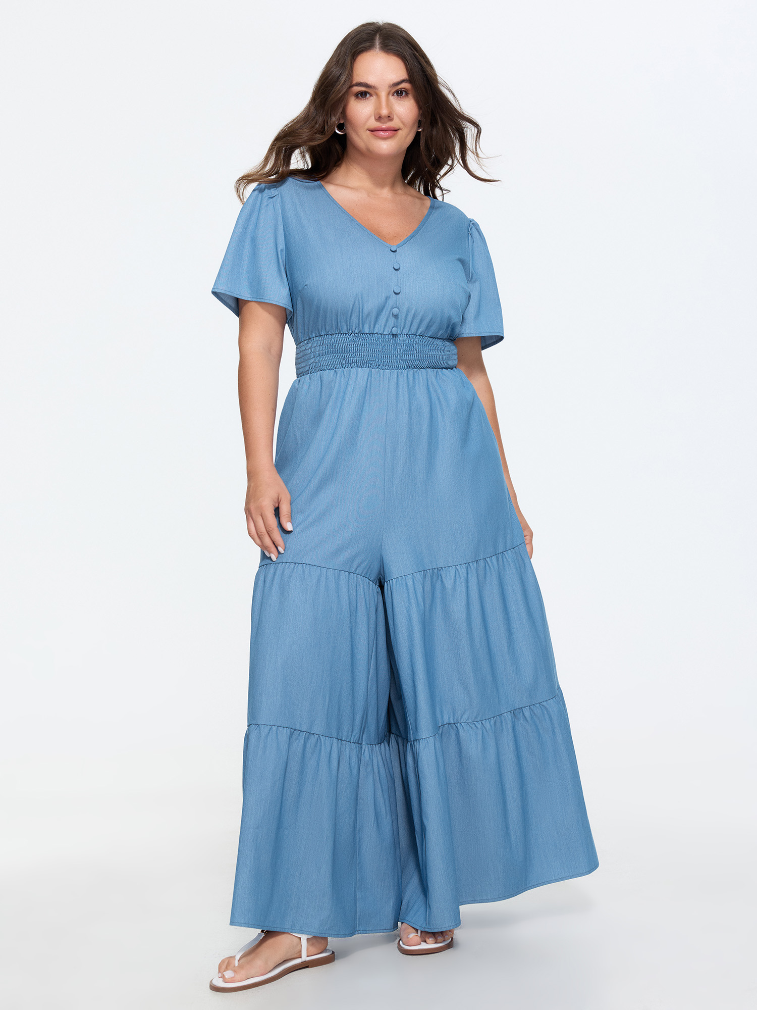 Side view of BloomChic Women's Plus Size Supersoft Button Detail Shirred Waist Faux Denim Jumpsuit Cerulean Casual 14-16/1X
