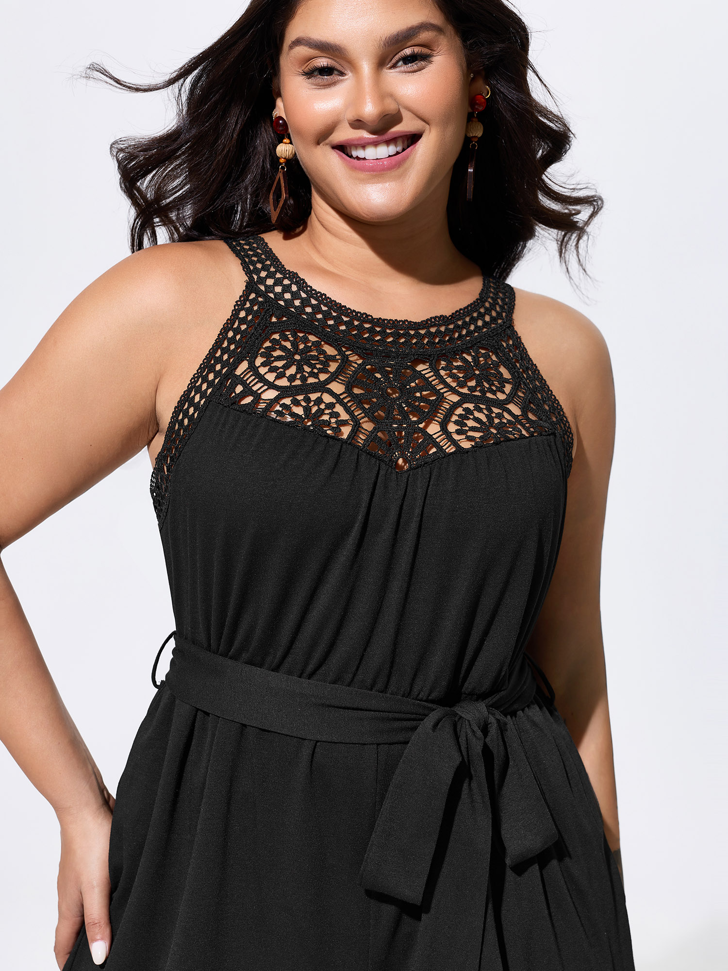 Side view of BloomChic Women's Plus Size Sheer Lace Neckline Waist-Tie Romper Black Vacation 28/5X