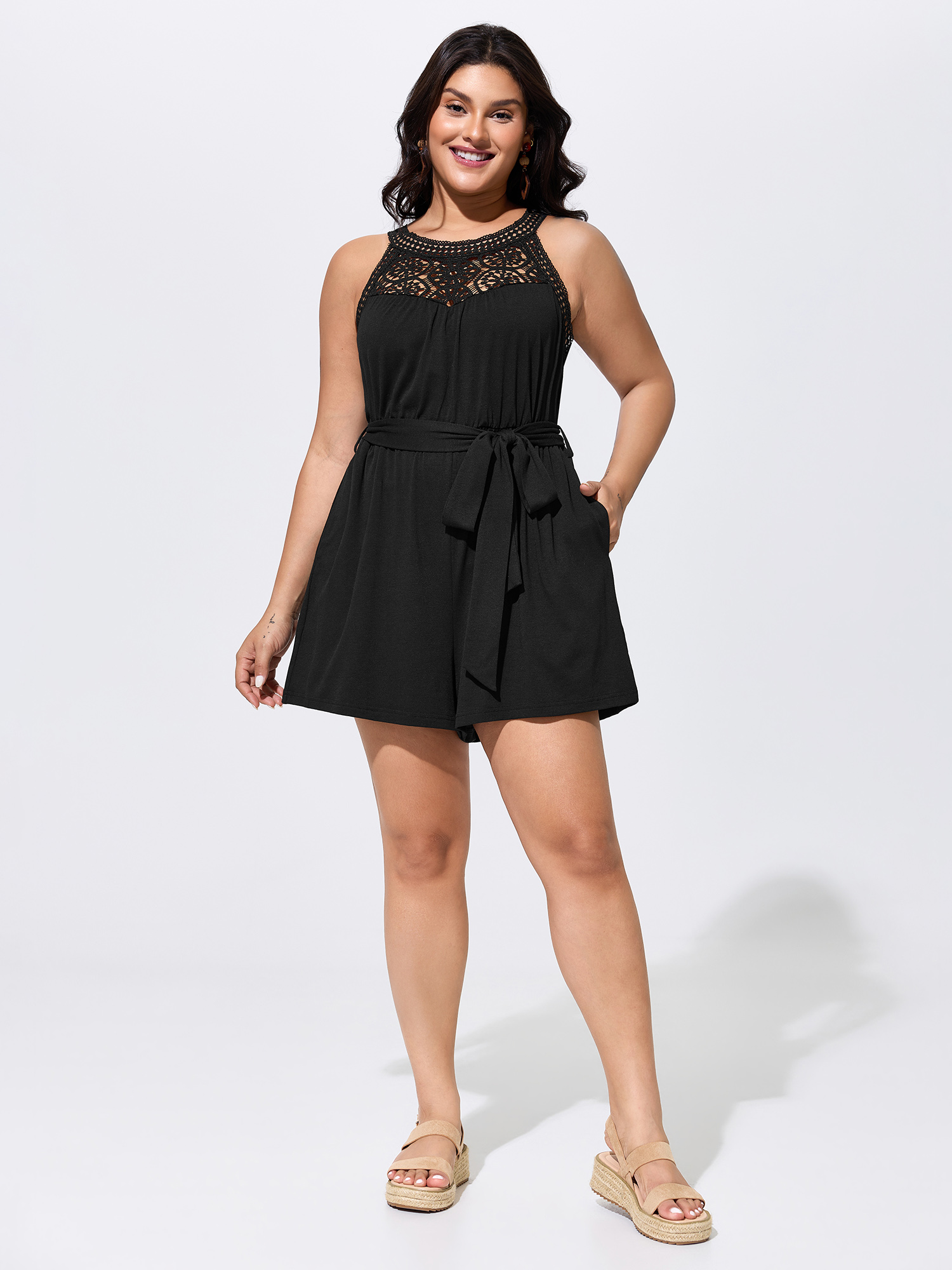 Side view of BloomChic Women's Plus Size Sheer Lace Neckline Waist-Tie Romper Black Vacation 28/5X