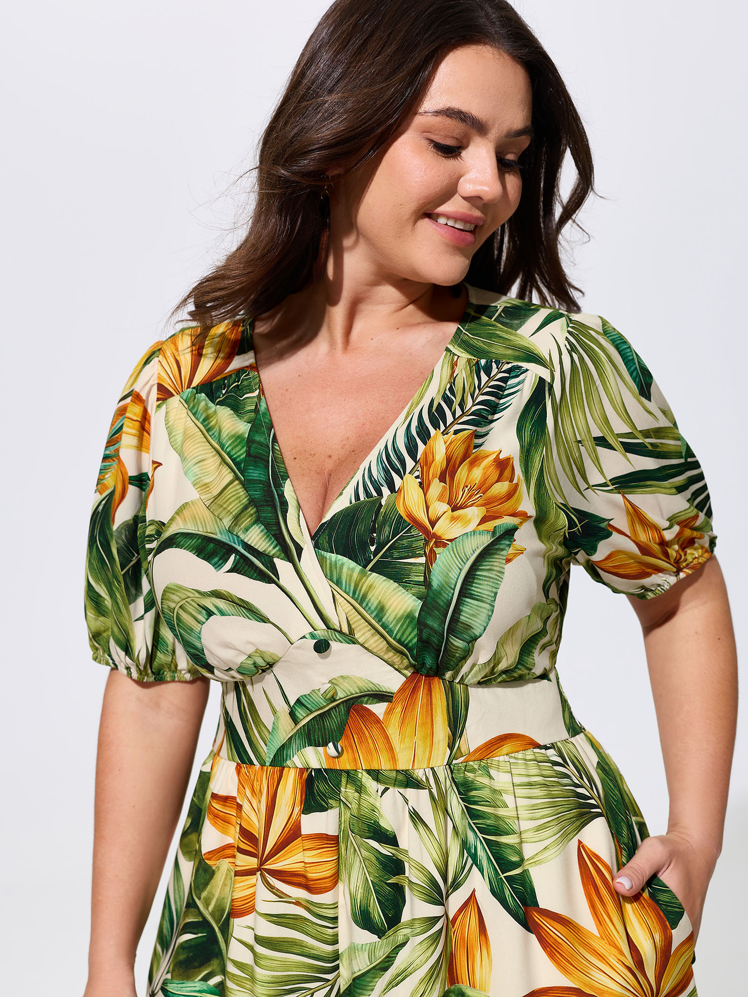 Side view of BloomChic Women's Plus Size Tropical Print Shirred Wide-Leg Romper Truegreen Vacation 26/4X