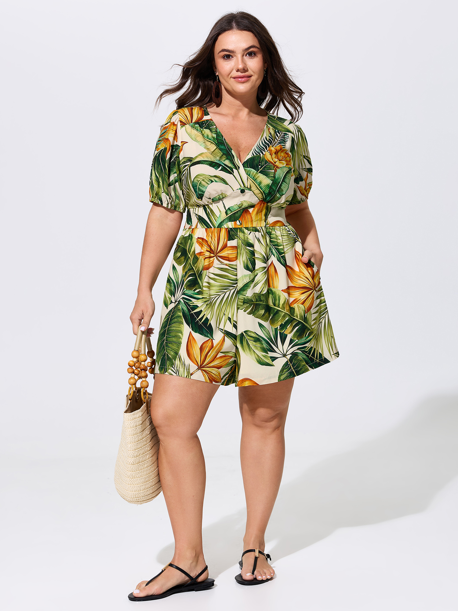 Side view of BloomChic Women's Plus Size Tropical Print Shirred Wide-Leg Romper Truegreen Vacation 26/4X