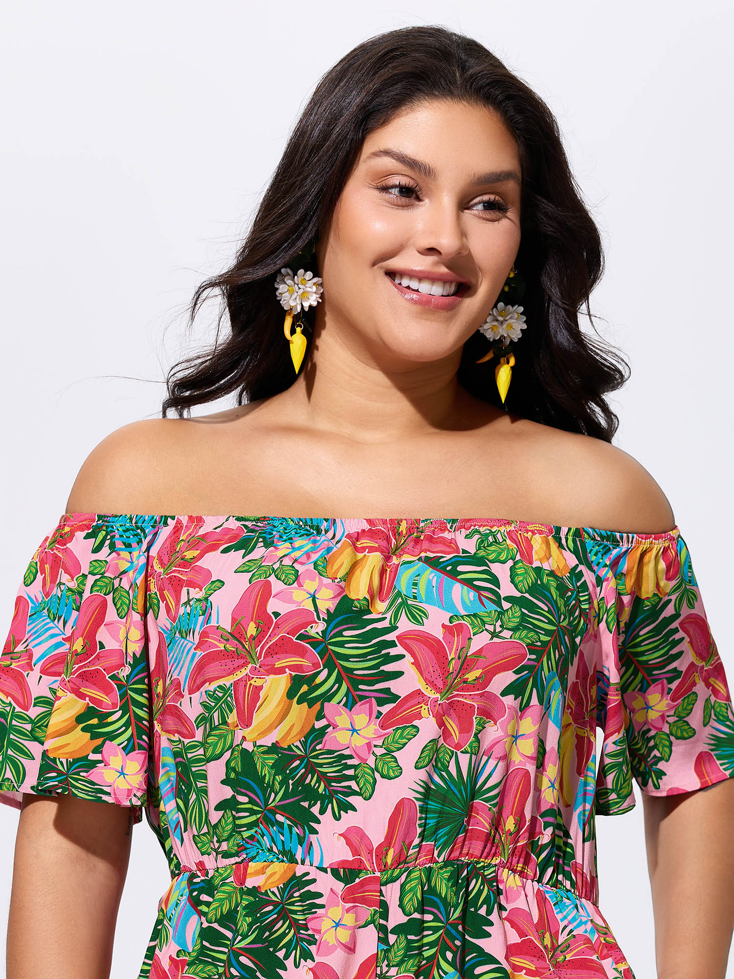 Side view of BloomChic Women's Plus Size Vibrant Floral Print Off-Shoulder Romper Blush Vacation 12/L