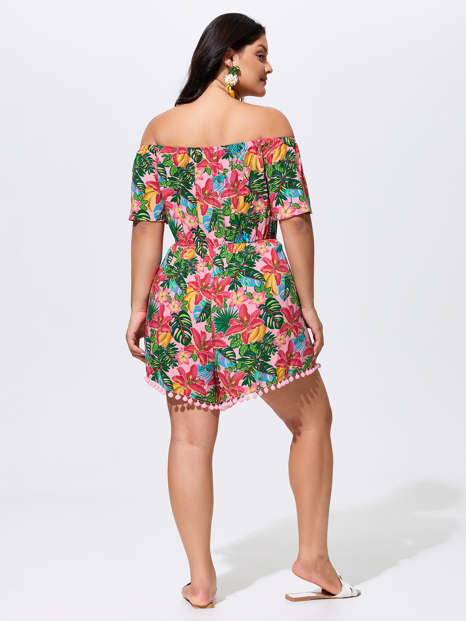 Side view of BloomChic Women's Plus Size Vibrant Floral Print Off-Shoulder Romper Blush Vacation 12/L