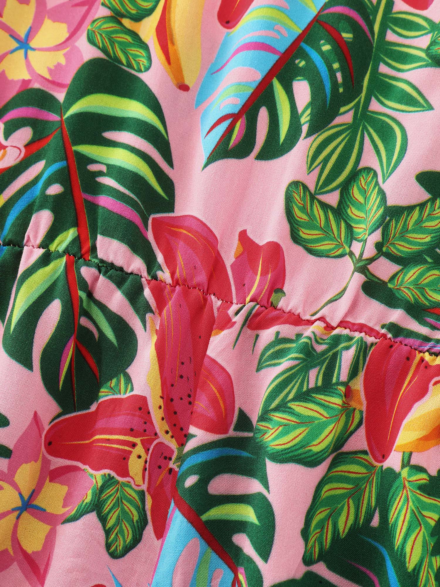 Side view of BloomChic Women's Plus Size Vibrant Floral Print Off-Shoulder Romper Blush Vacation 12/L