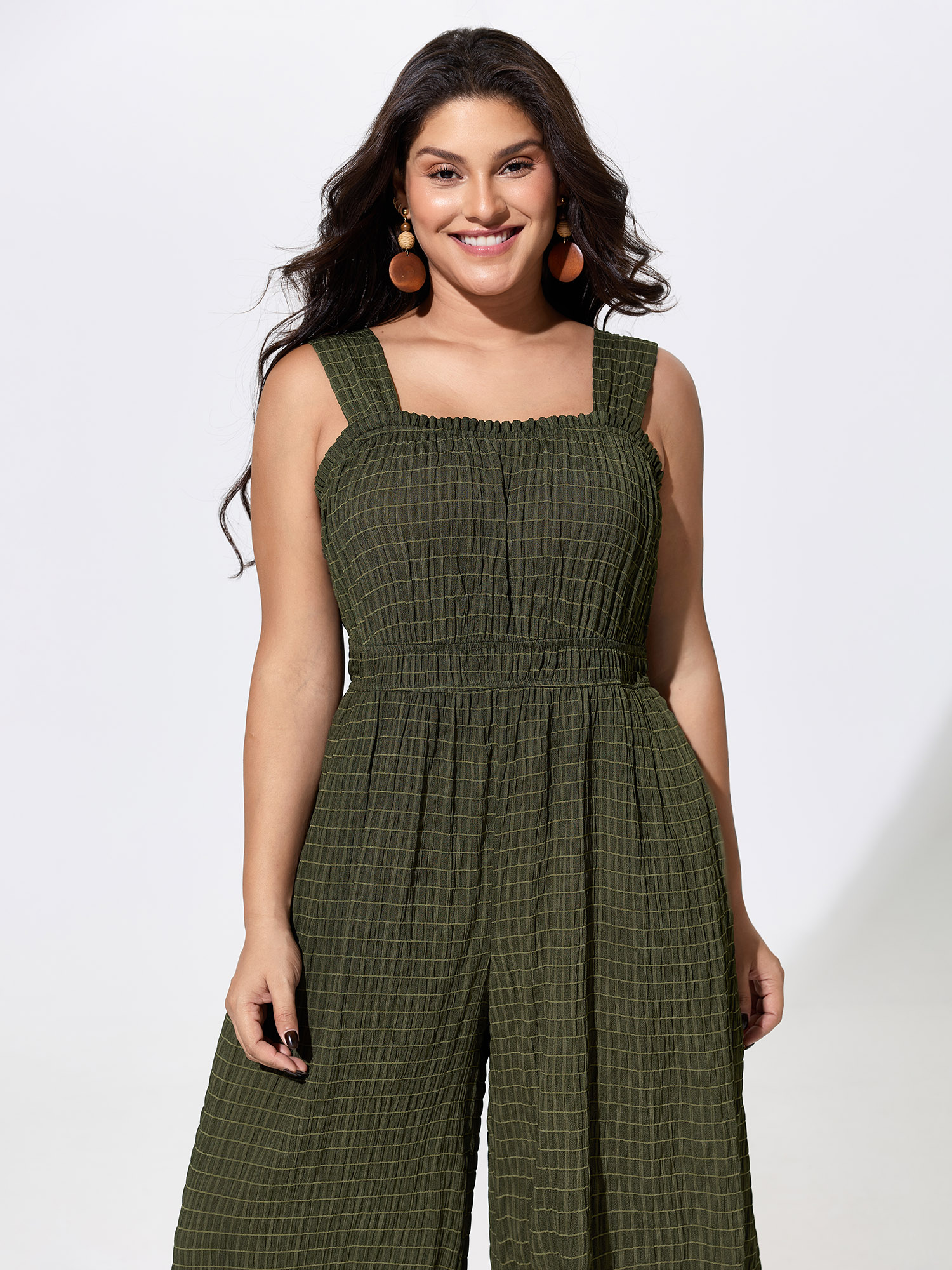 Side view of BloomChic Women's Plus Size Textured Wide Straps Shirred Waist Jumpsuit ArmyGreen Vacation 12/L