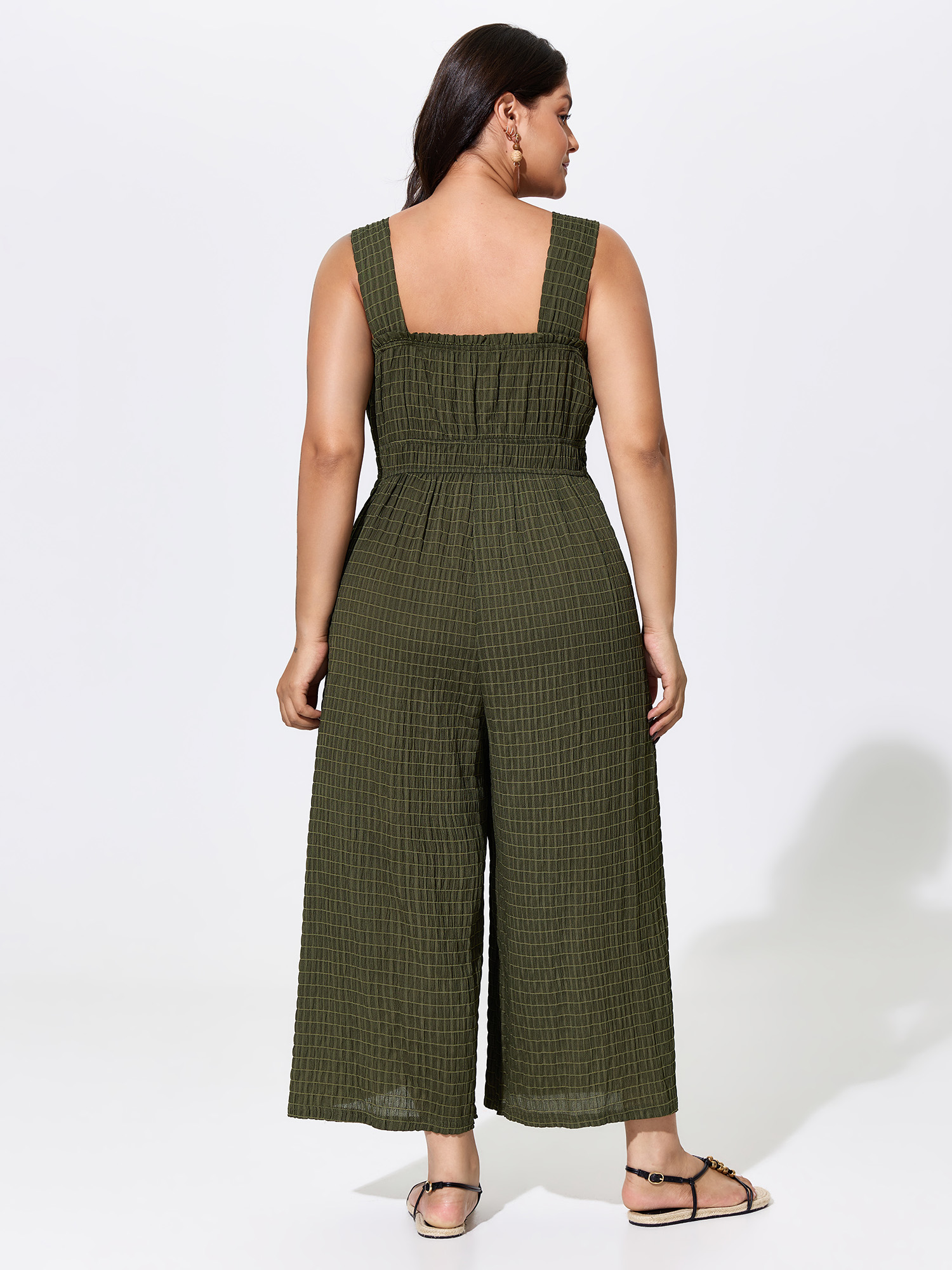 Side view of BloomChic Women's Plus Size Textured Wide Straps Shirred Waist Jumpsuit ArmyGreen Vacation 12/L