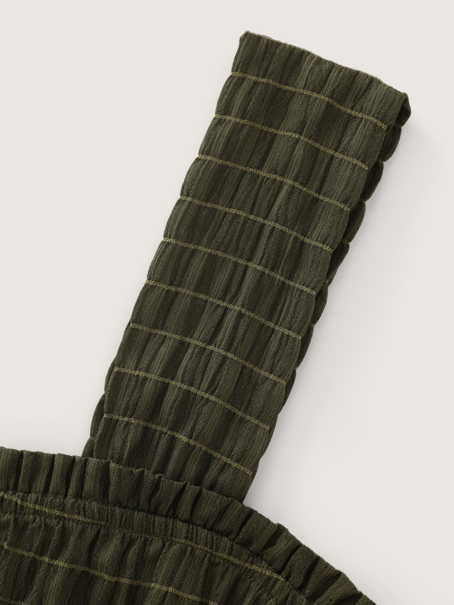 Side view of BloomChic Women's Plus Size Textured Wide Straps Shirred Waist Jumpsuit ArmyGreen Vacation 12/L