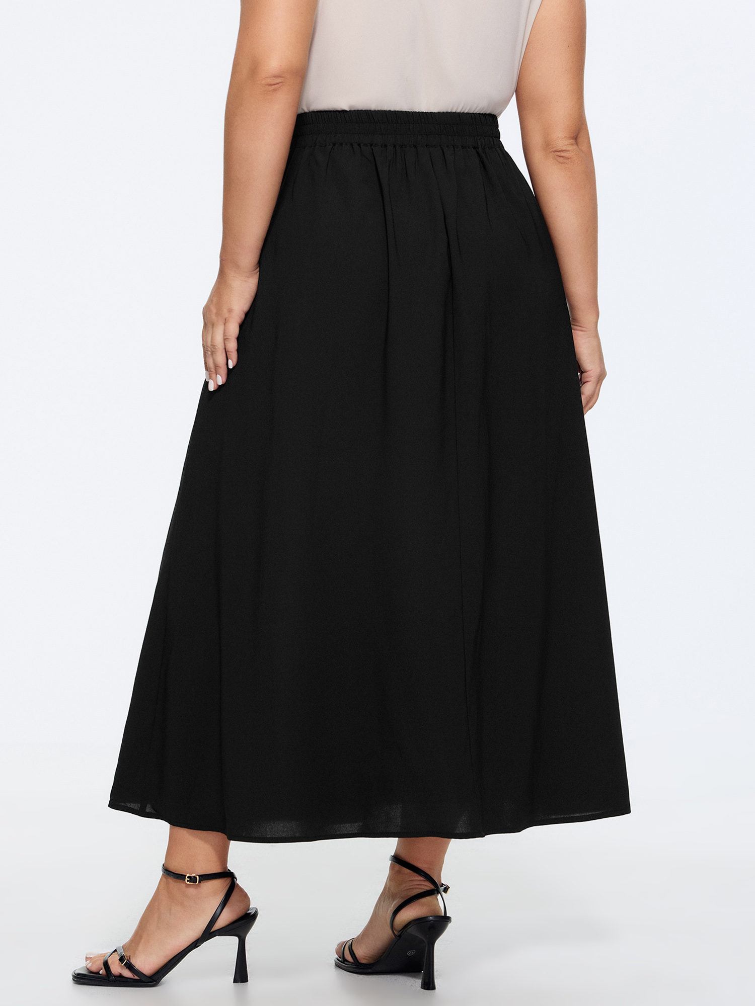 Side view of BloomChic Women's Plus Size Waist Beaded Pleated Flowy Maxi Skirt Black Wide Waistband Flared Office 14-16/1X