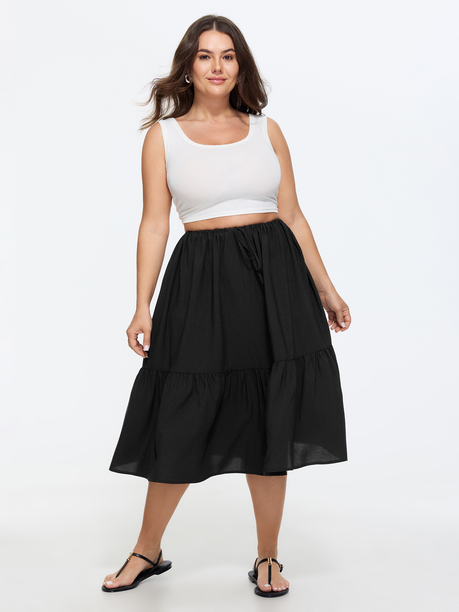 Side view of BloomChic Women's Plus Size Adjustable Drawstring Waist Plain Tiered Flowy Midi Skirt Black Non A-line Casual 30/6X