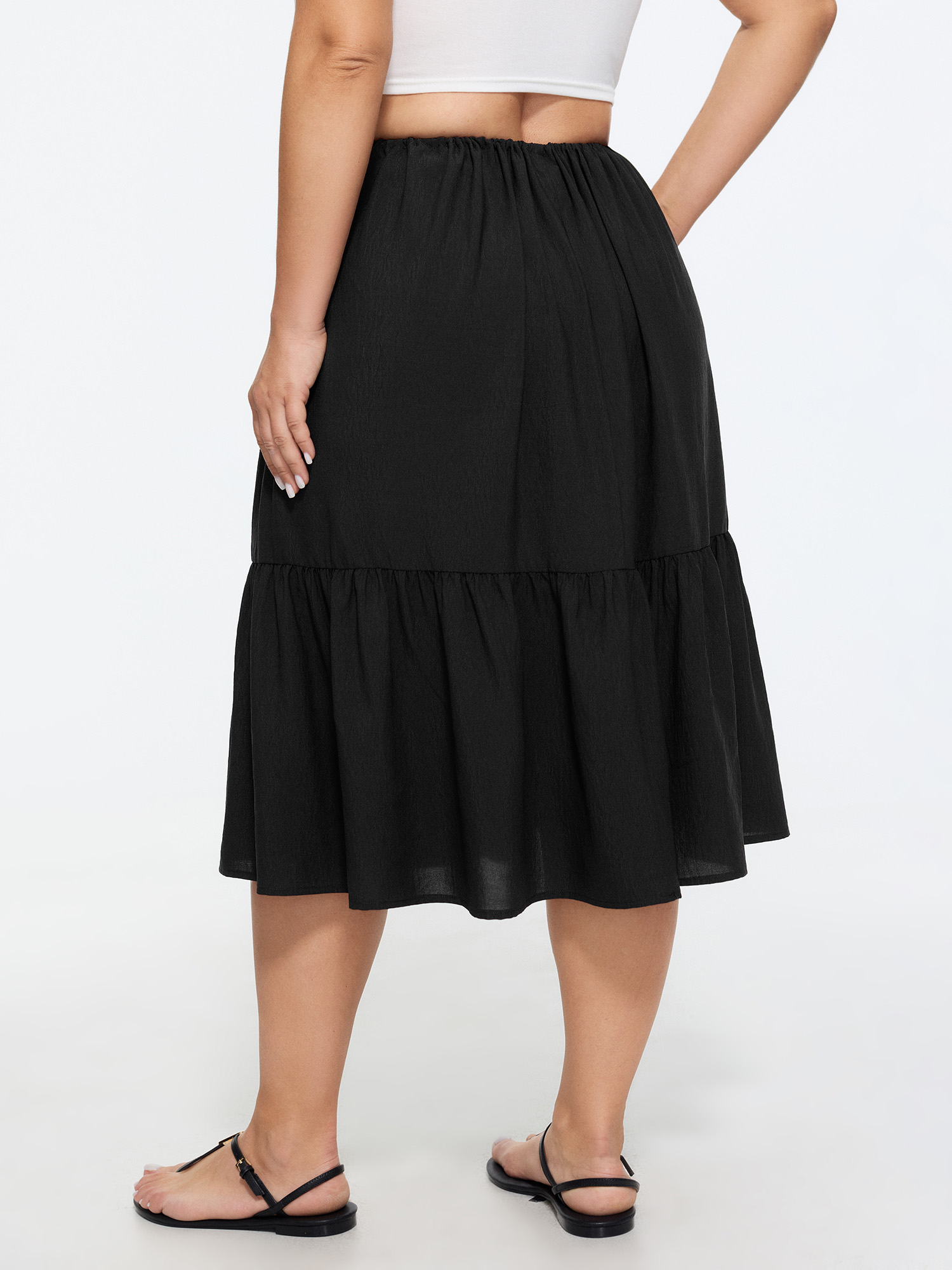 Side view of BloomChic Women's Plus Size Adjustable Drawstring Waist Plain Tiered Flowy Midi Skirt Black Non A-line Casual 30/6X