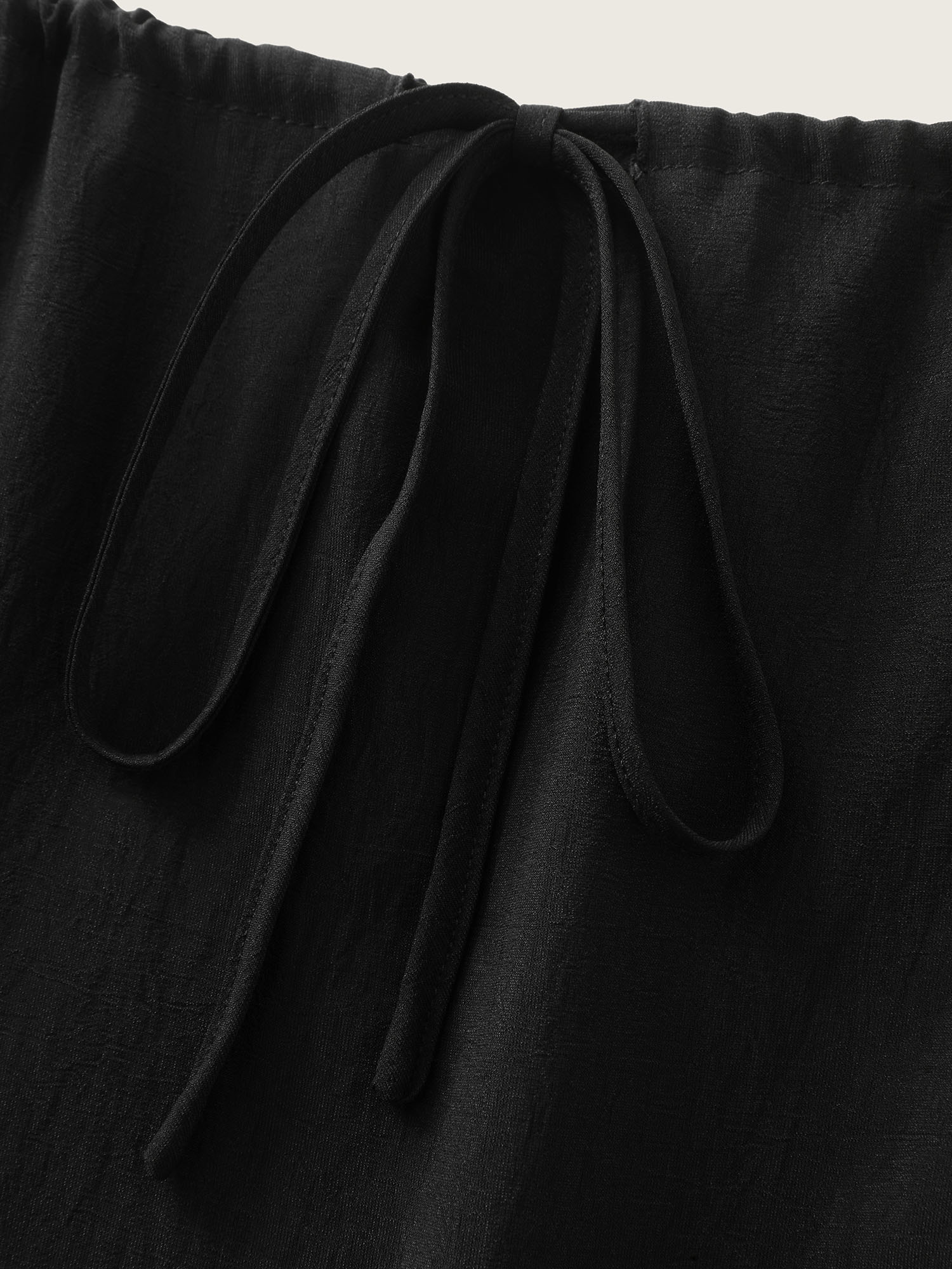 Side view of BloomChic Women's Plus Size Adjustable Drawstring Waist Plain Tiered Flowy Midi Skirt Black Non A-line Casual 30/6X