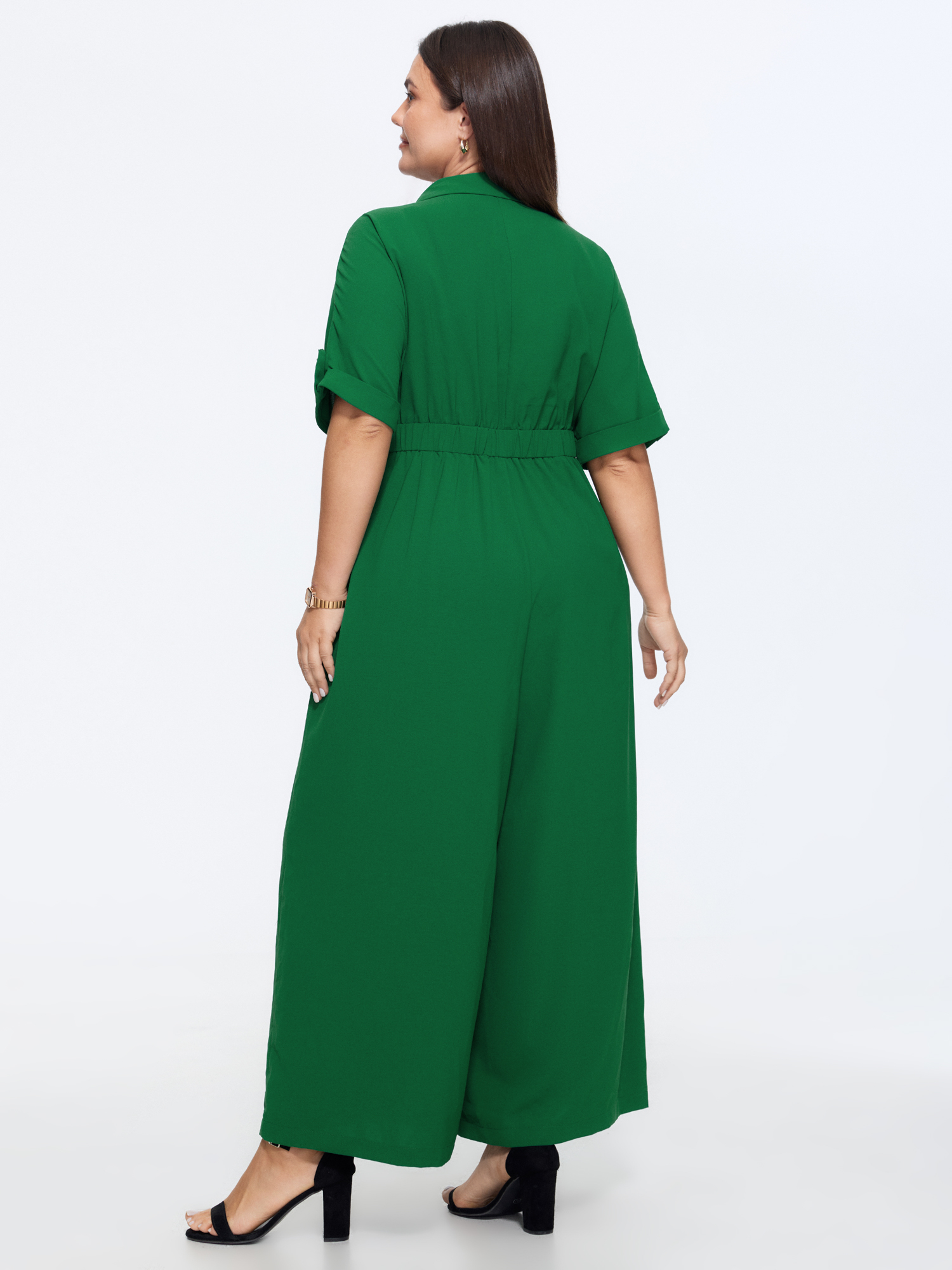 Side view of BloomChic Women's Plus Size Button Placket Pockets Wide-Leg Jumpsuit Emerald Office 10/M