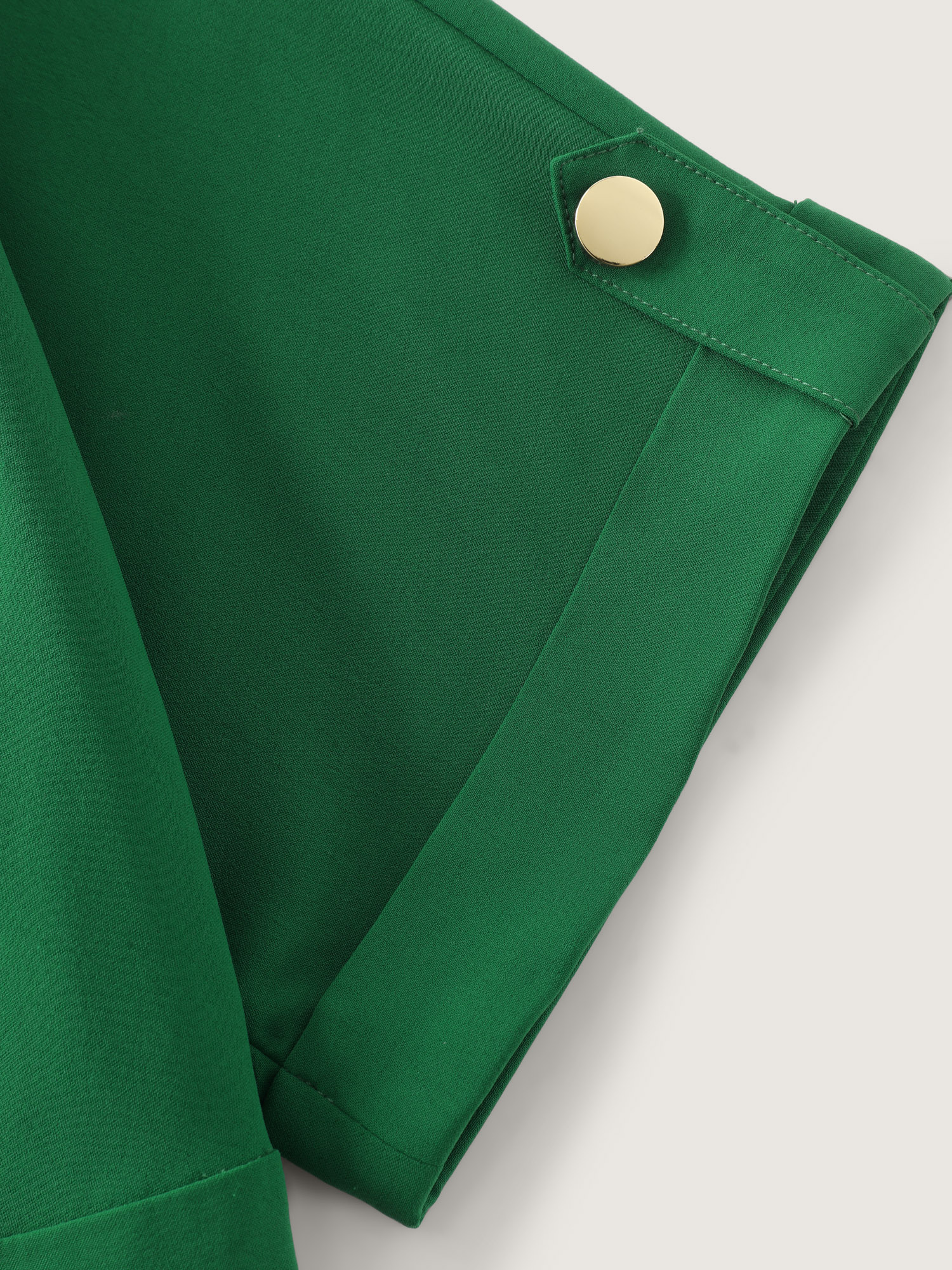 Side view of BloomChic Women's Plus Size Button Placket Pockets Wide-Leg Jumpsuit Emerald Office 10/M