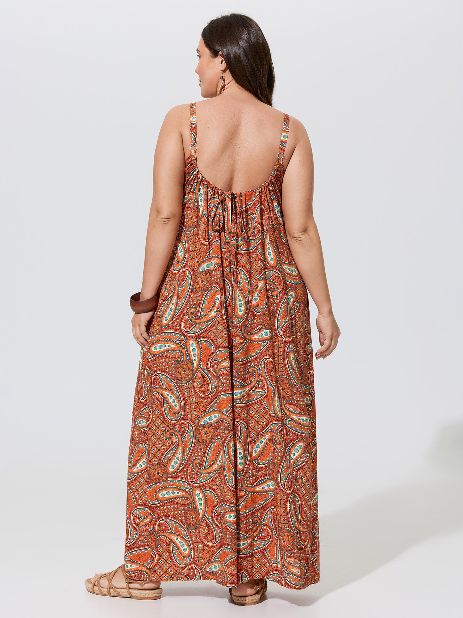 Side view of BloomChic Women's Plus Size Paisley Print Backless Sleeveless Jumpsuit Brightorange Vacation Relaxed Fit 14-16/1X