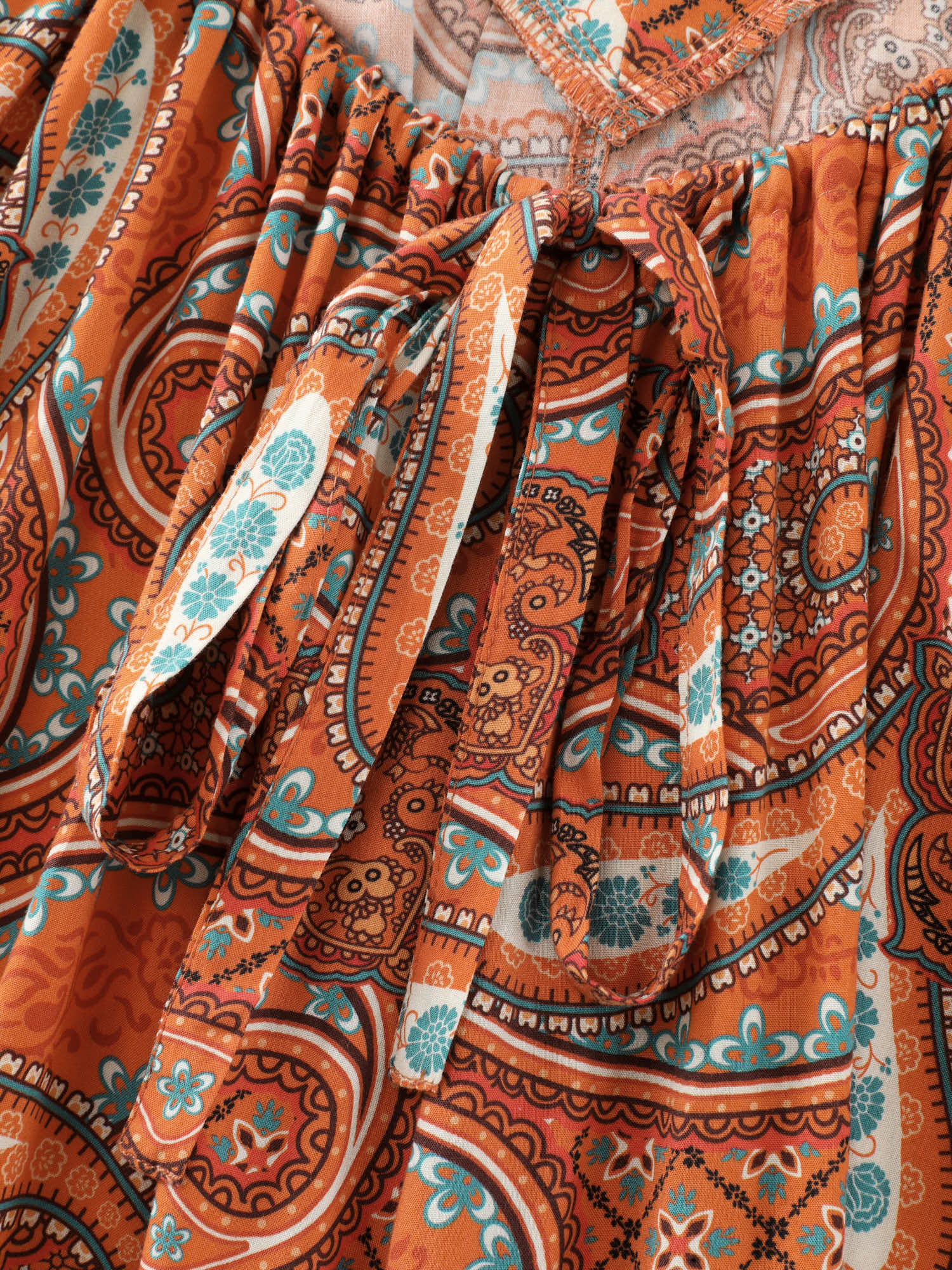 Side view of BloomChic Women's Plus Size Paisley Print Backless Sleeveless Jumpsuit Brightorange Vacation Relaxed Fit 14-16/1X