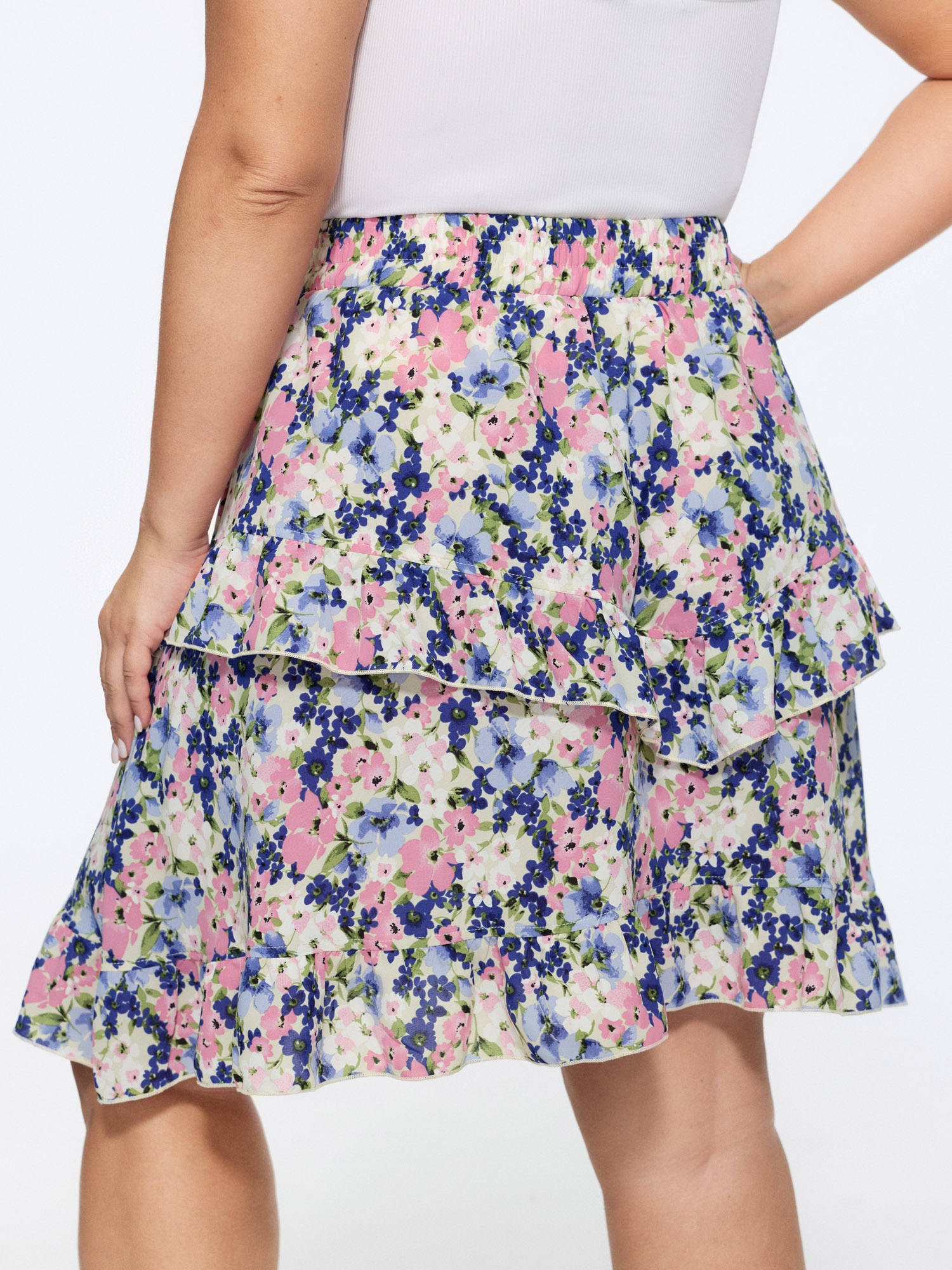 Side view of BloomChic Women's Plus Size Floral Print Ruffled Edge Mini Skirt Navy Casual 14-16/1X